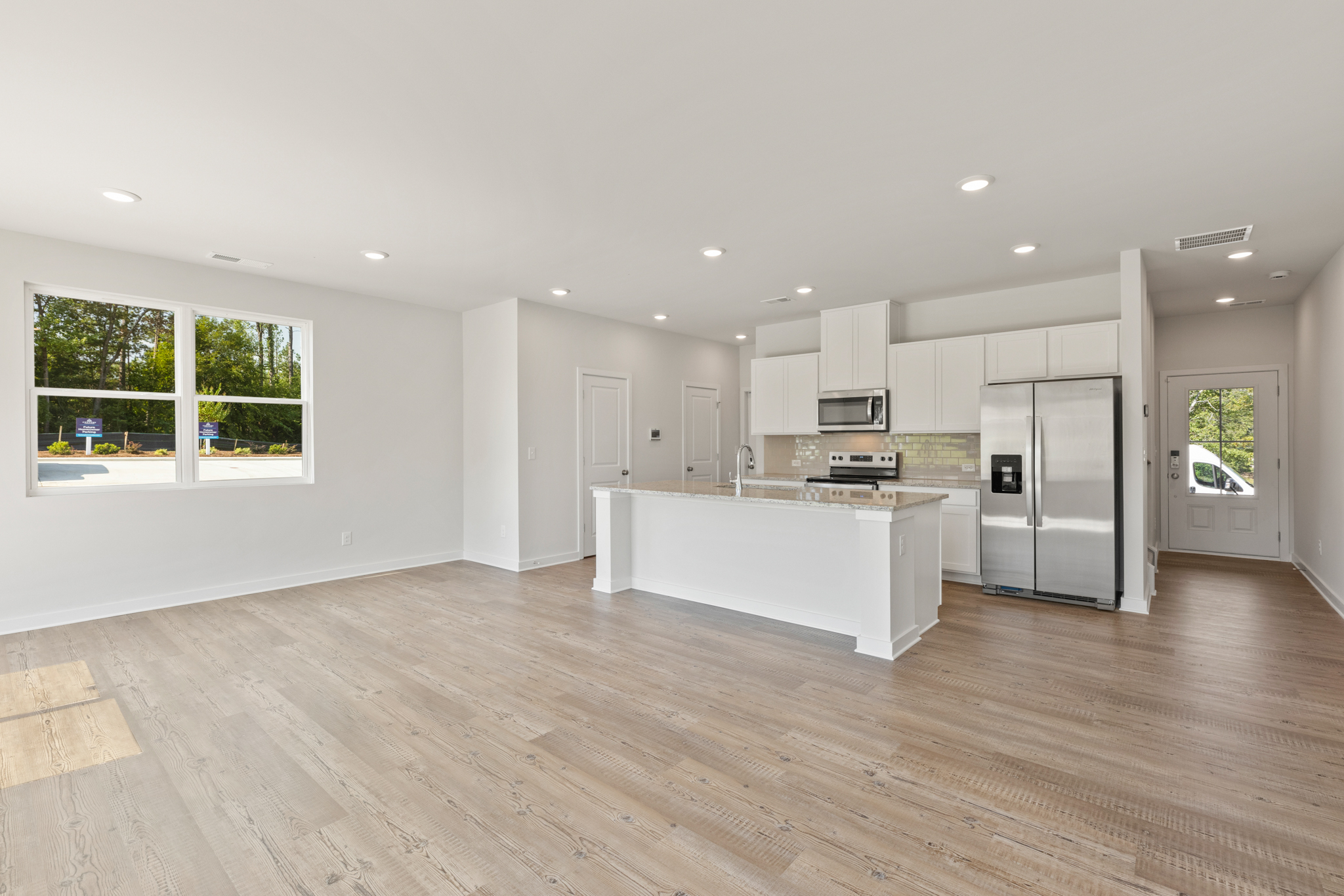 A kitchen with white cabinets.