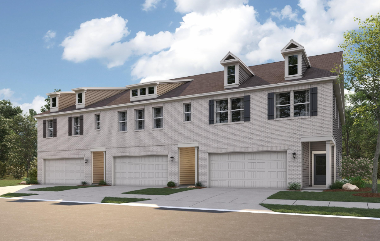 A large white house with garages.