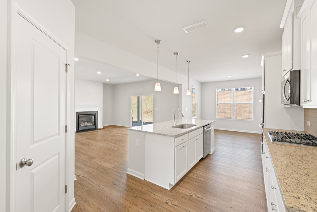 A kitchen with white cabinets.