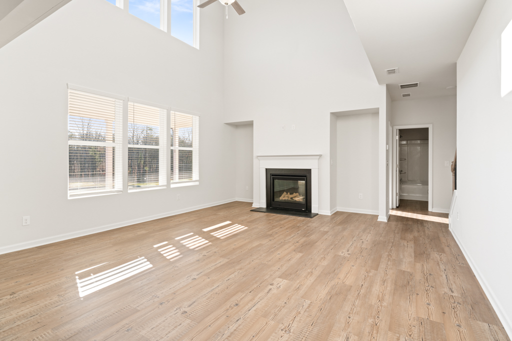 A room with a fireplace and wood floors.