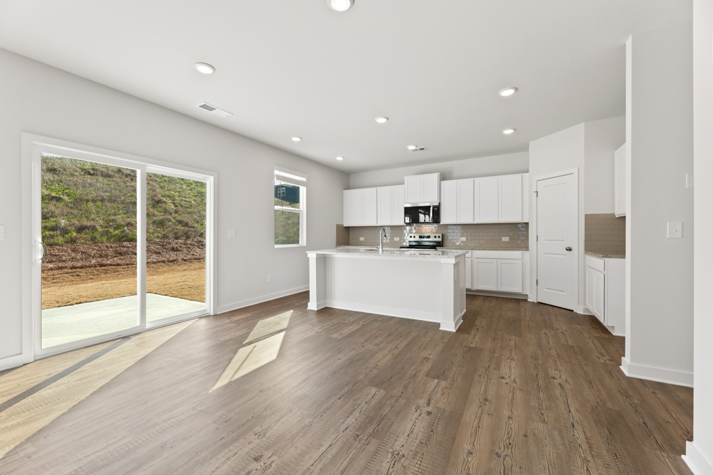 A large kitchen with white cabinets.