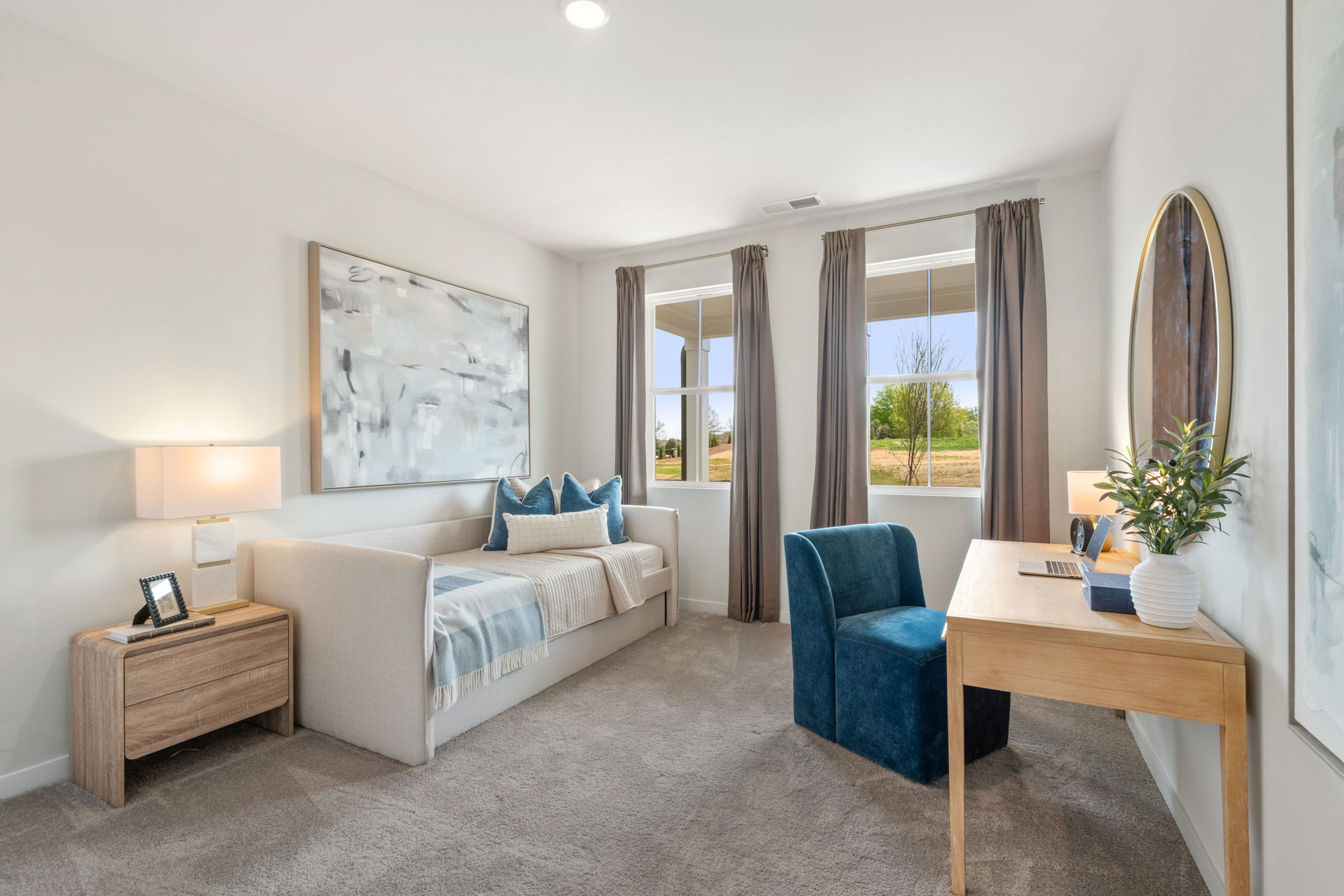 A bedroom with a bed and a desk.