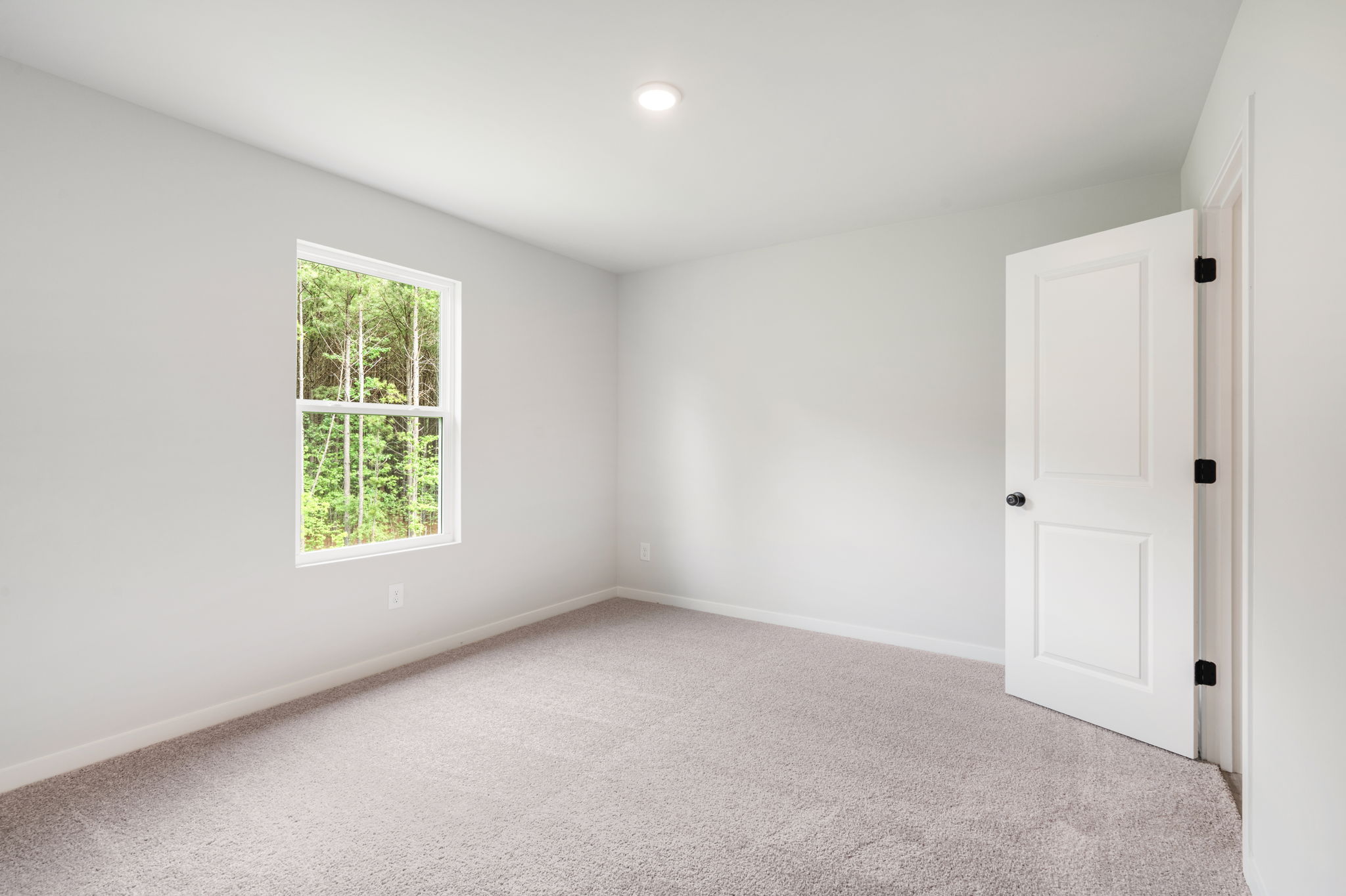 A room with a window and a door.