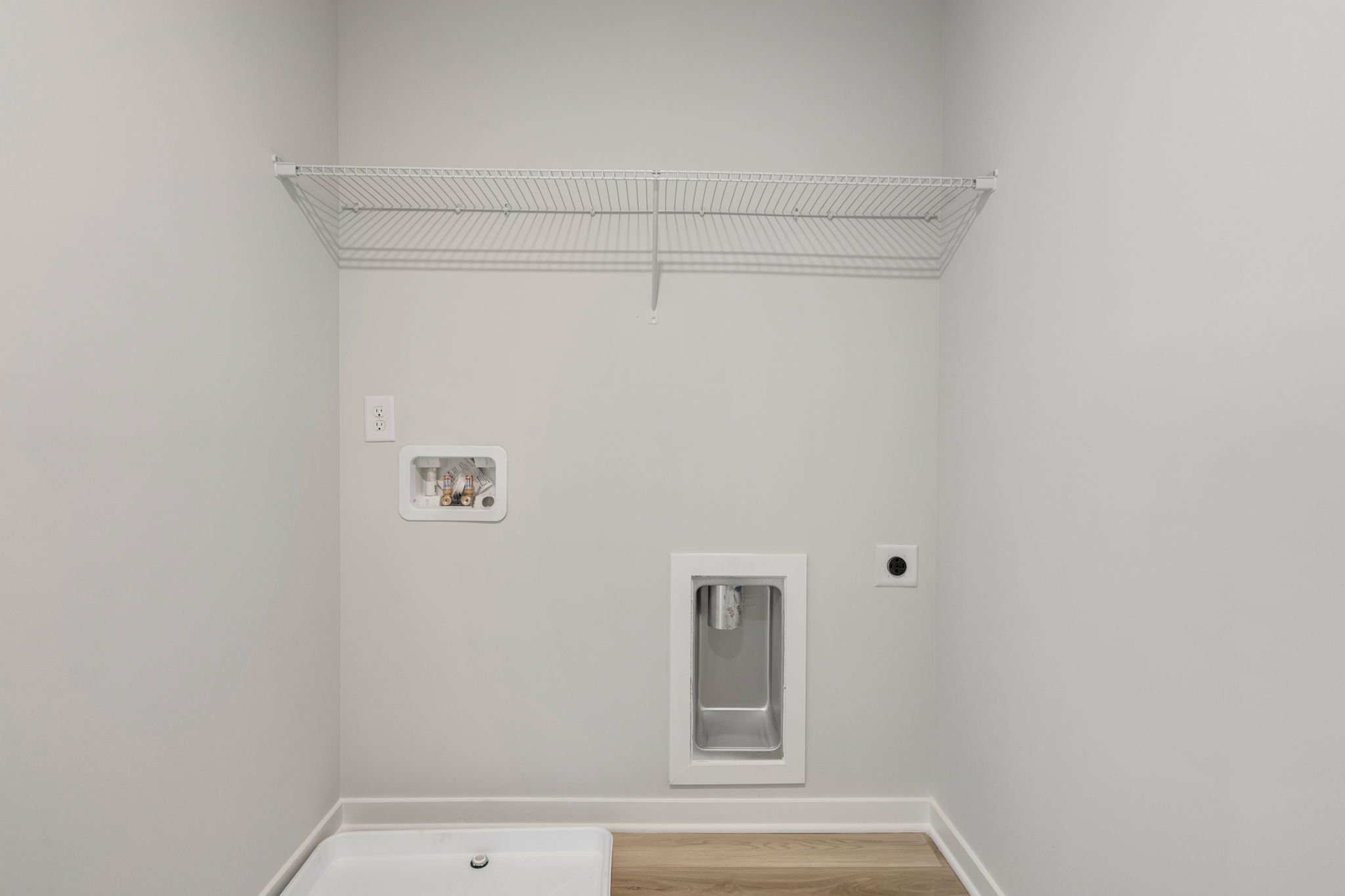 A white wall with a vent.