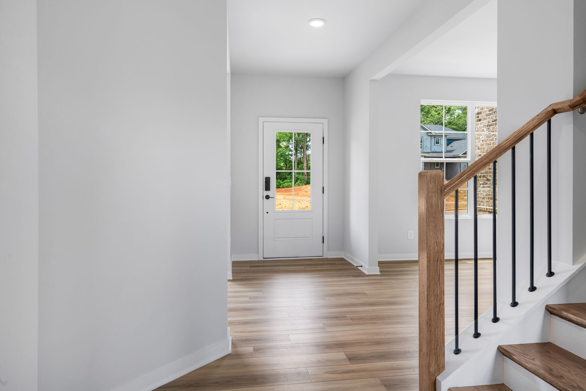 A room with a wood floor and white walls.
