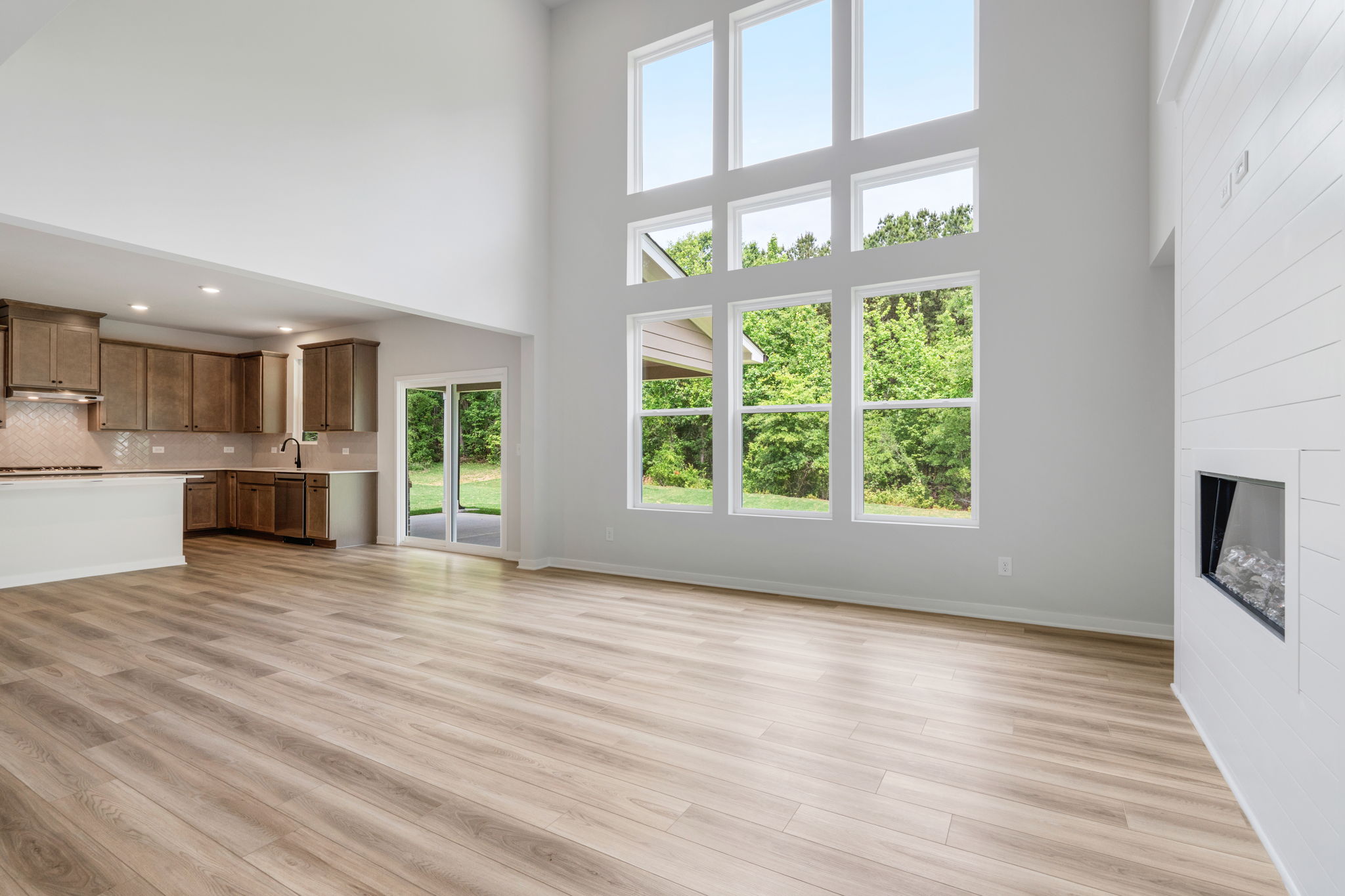 A room with a wood floor and a window with a wood floor.