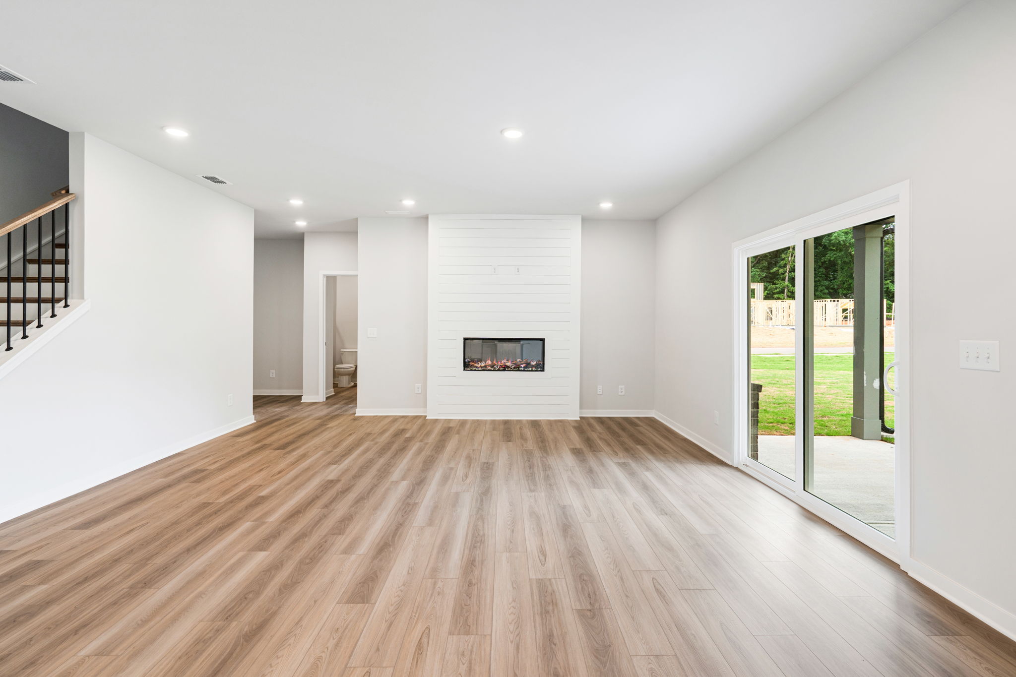 A room with a fireplace and a wood floor.