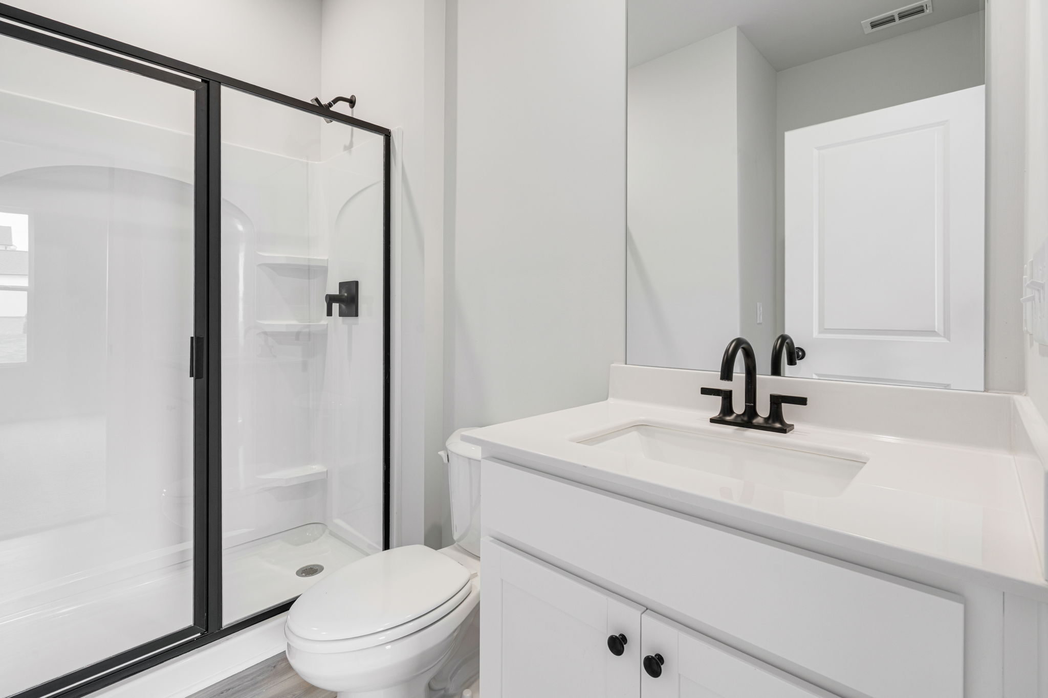 A bathroom with a glass shower.