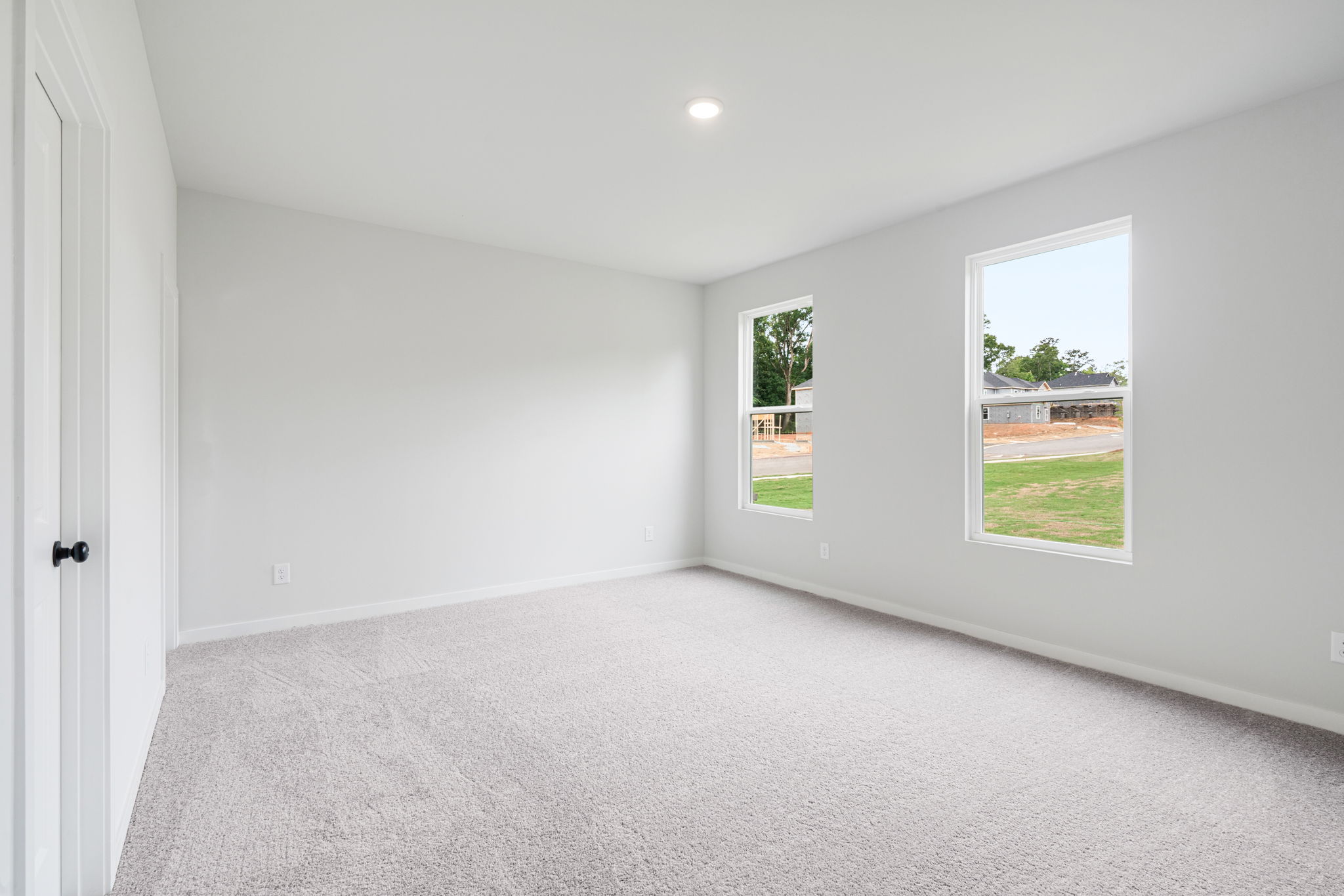 A room with a window and a door.