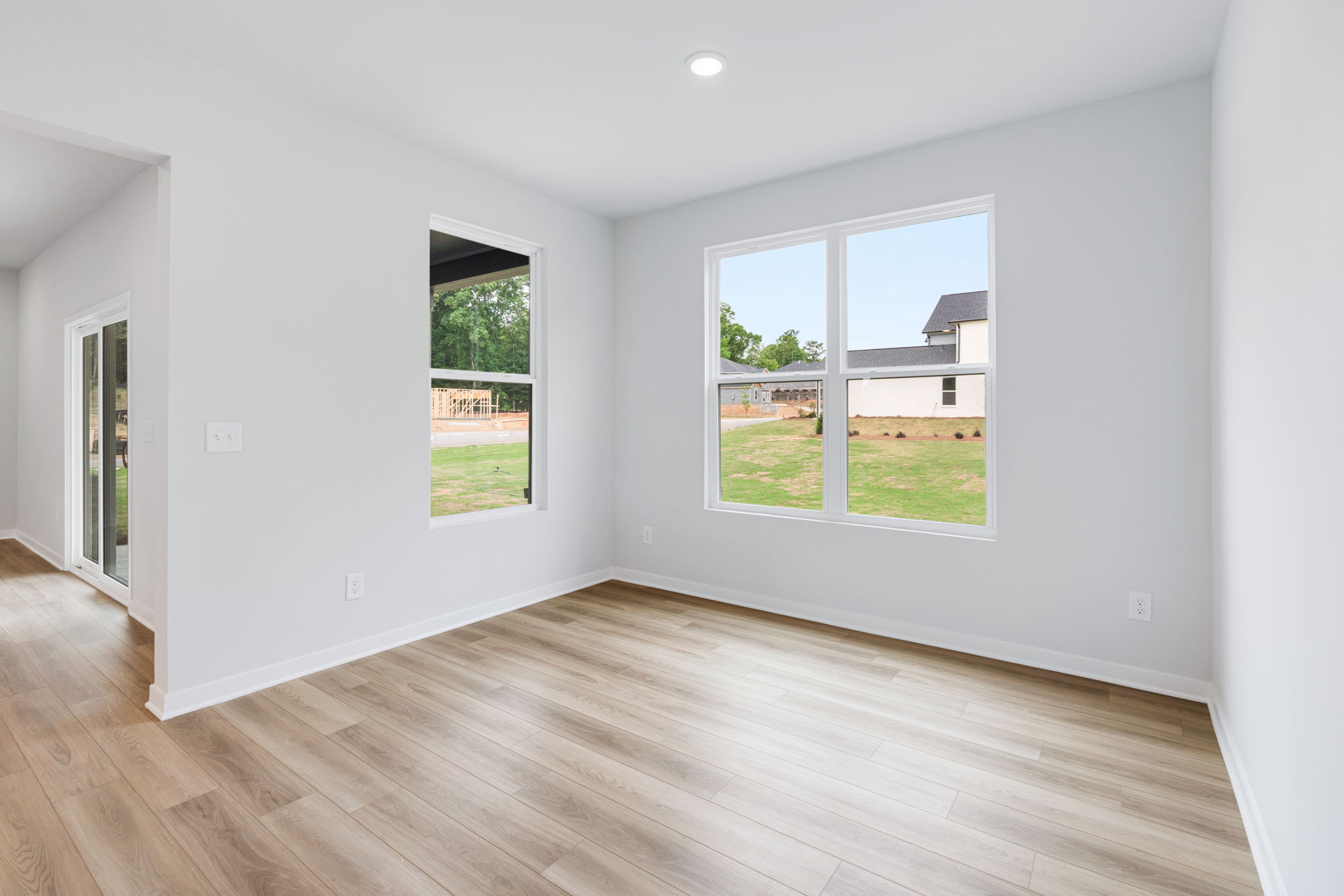 A room with a wood floor and windows.