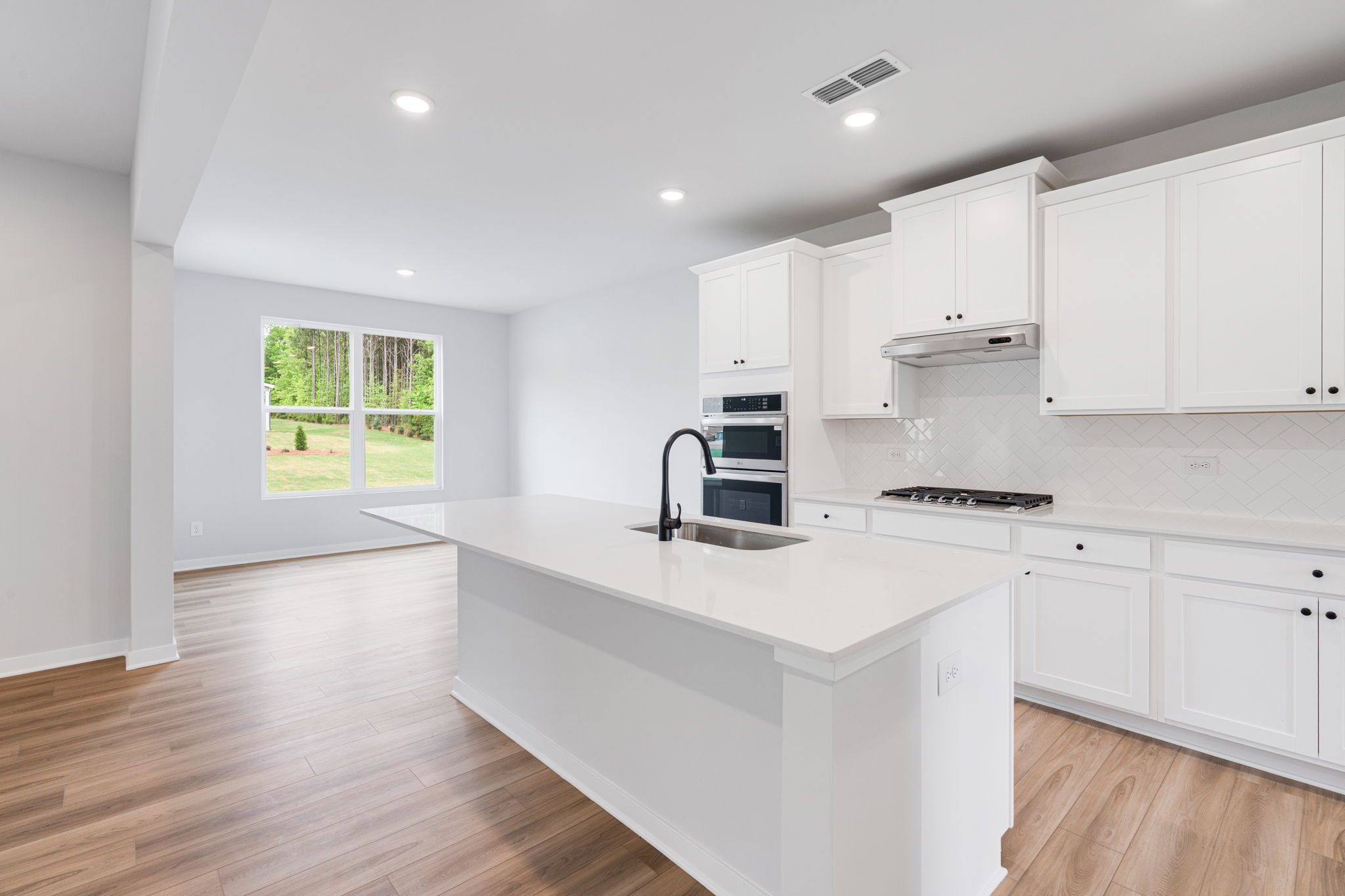 A kitchen with white cabinets.