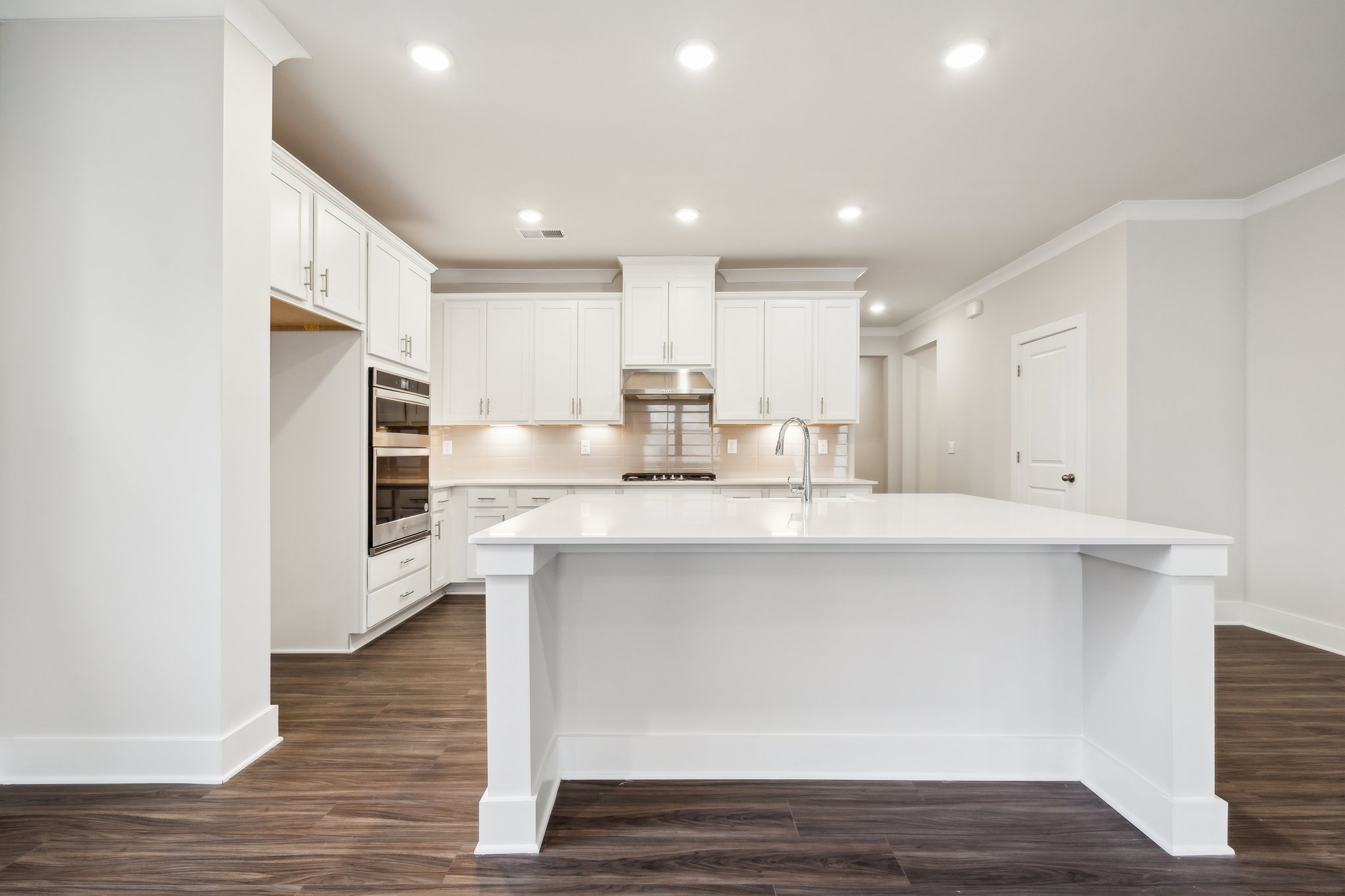 A kitchen with white cabinets.