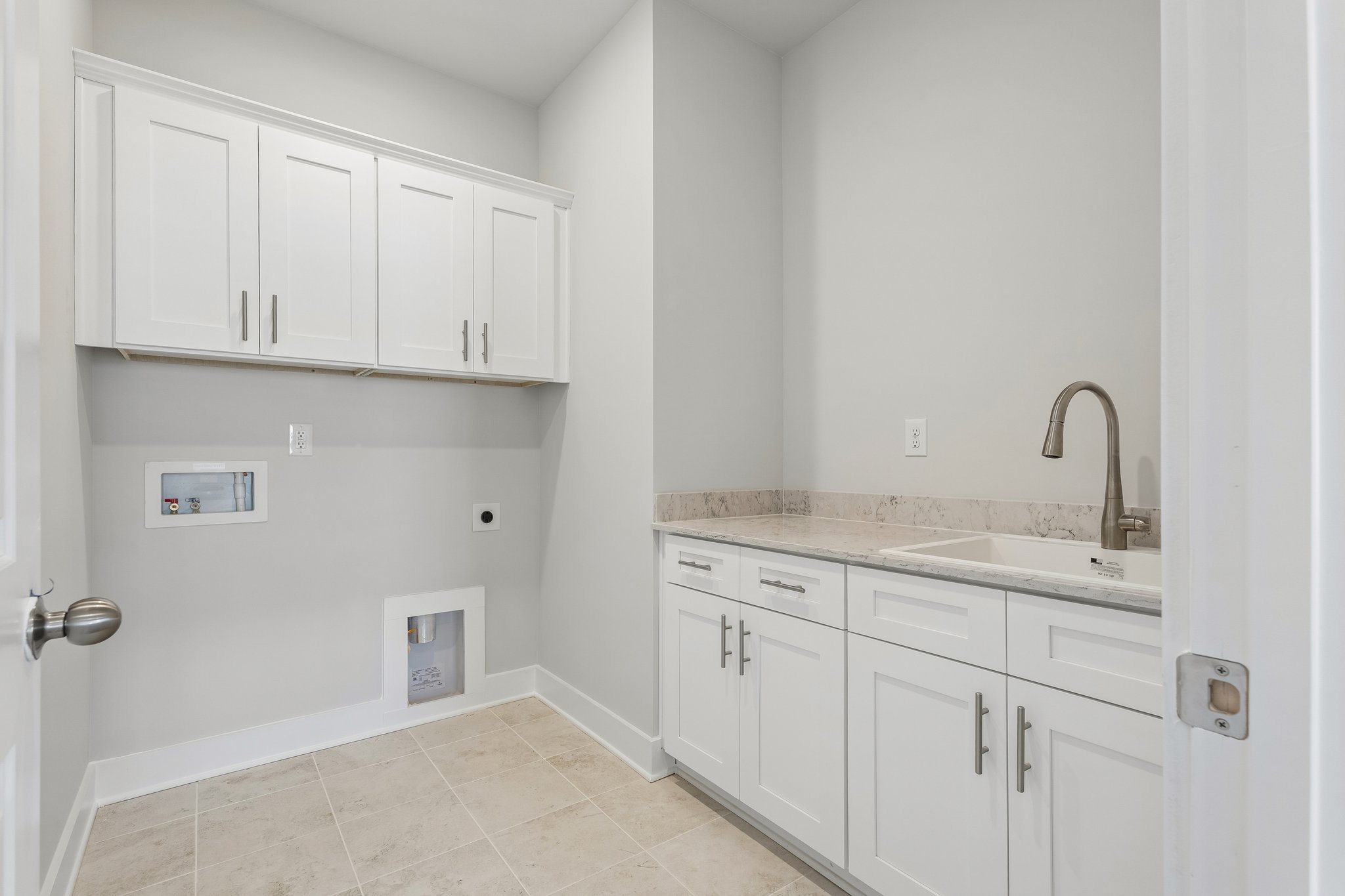 A kitchen with white cabinets.