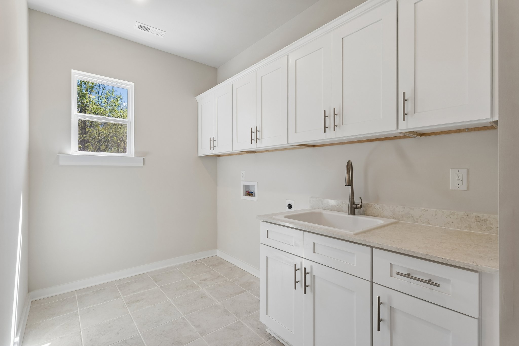 A kitchen with white cabinets.