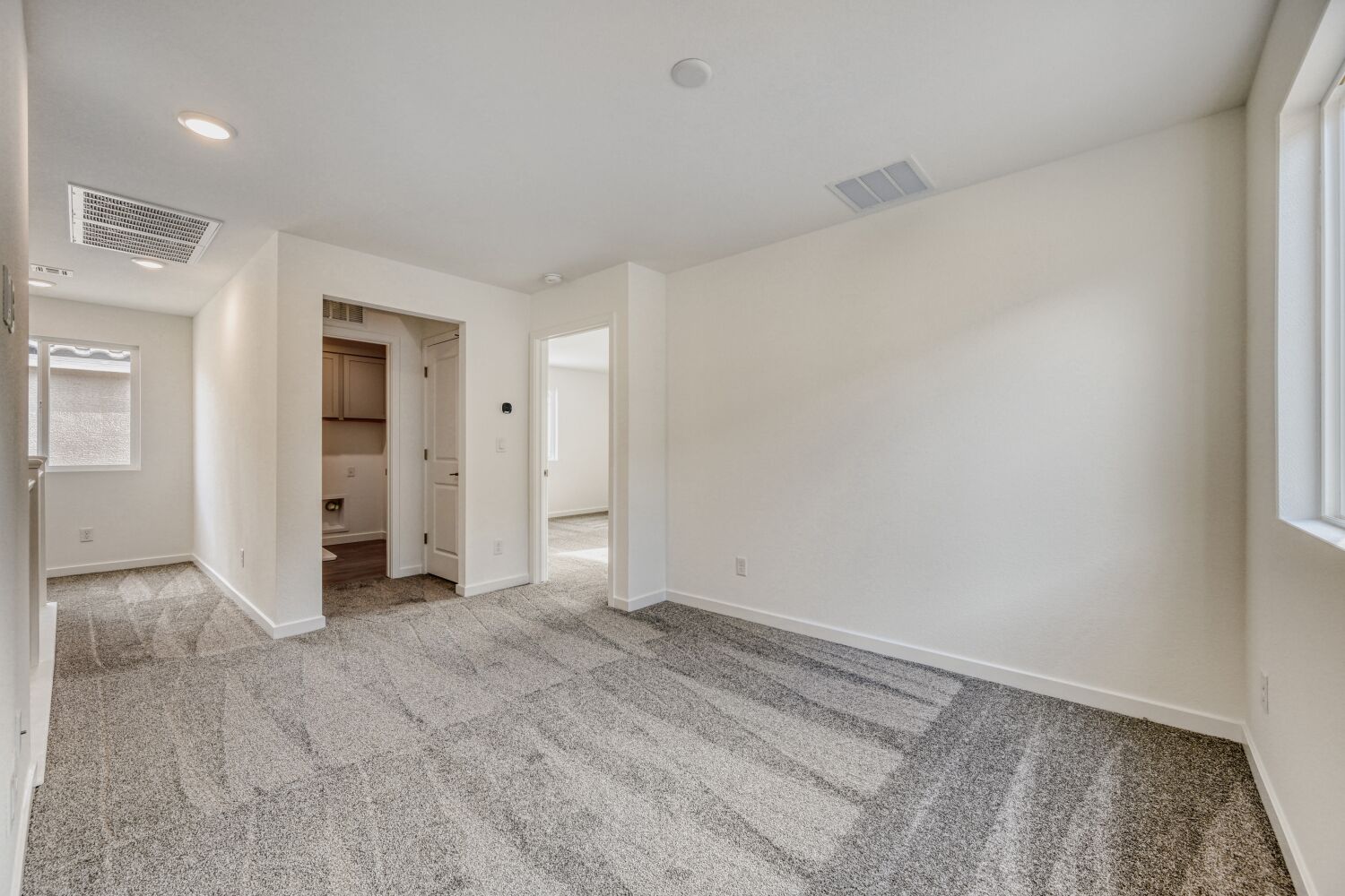 A room with a carpet and a rug.