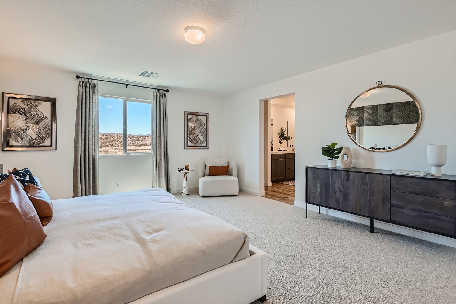 A bedroom with a large mirror.