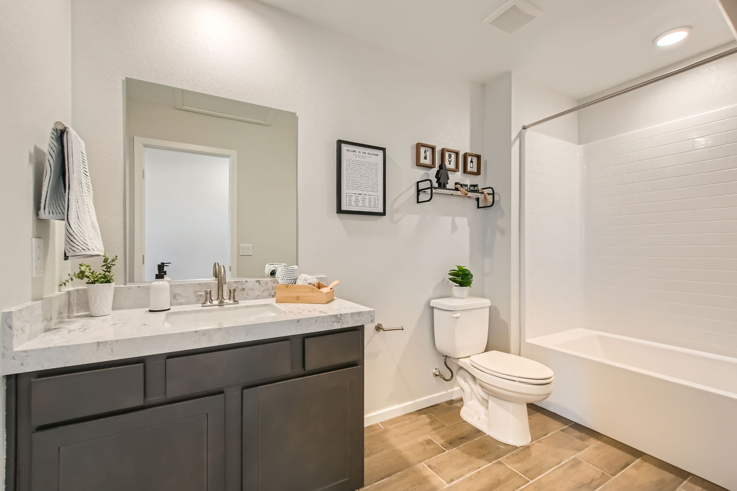 A bathroom with a tub toilet and sink.