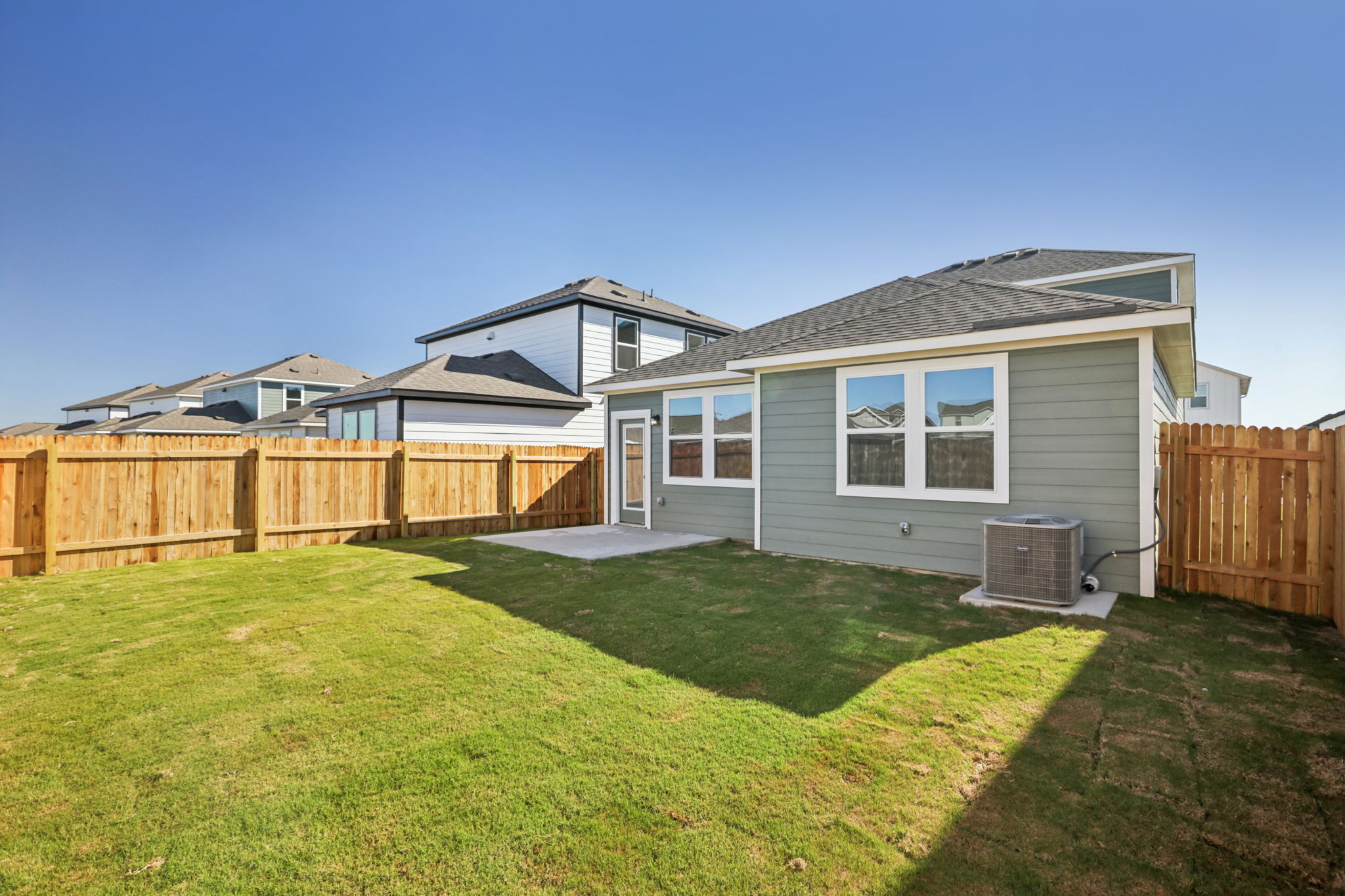 A house with a fence and grass.