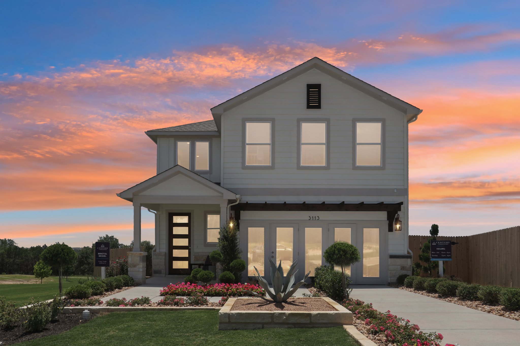 A house with a fountain in front of it.