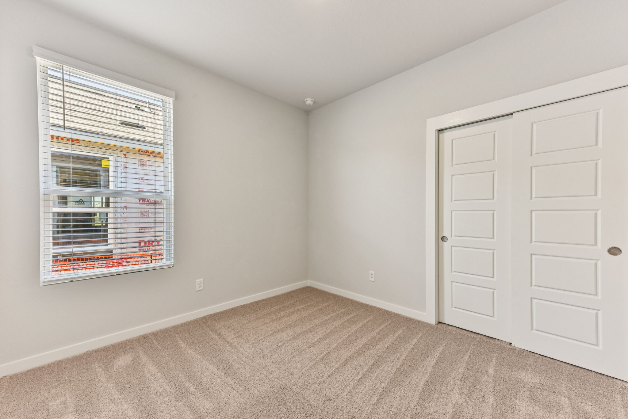 A room with a window and a door.