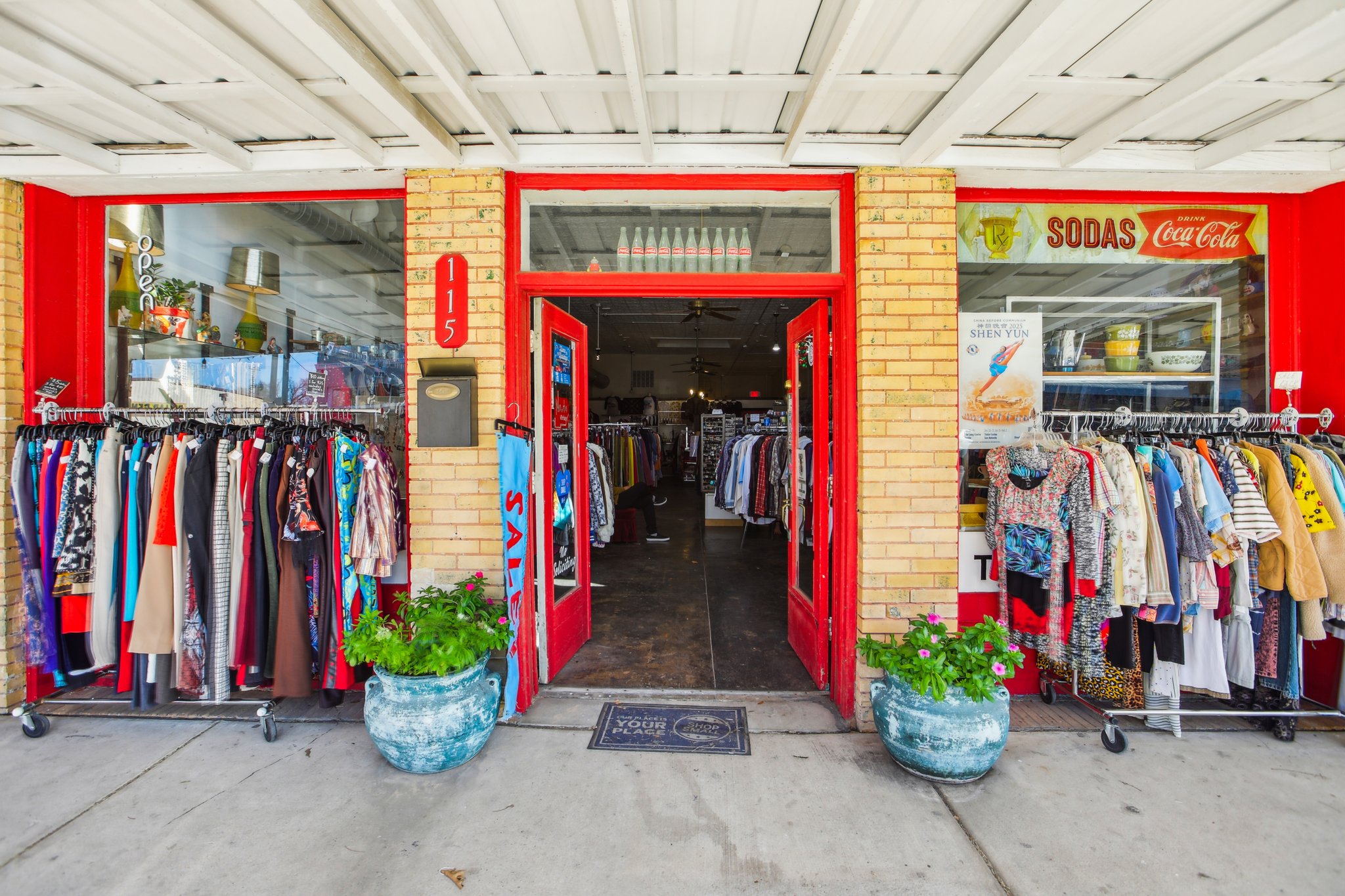 A store front with a large display of clothes.