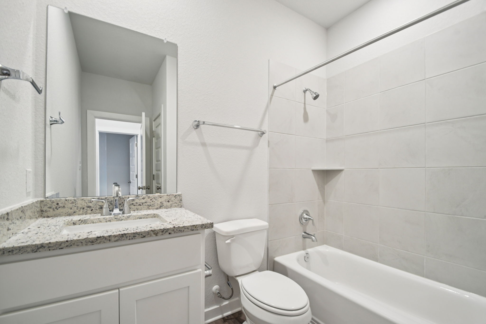 A bathroom with a tub sink and toilet.