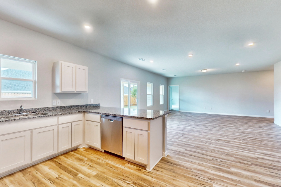 A kitchen with white cabinets.