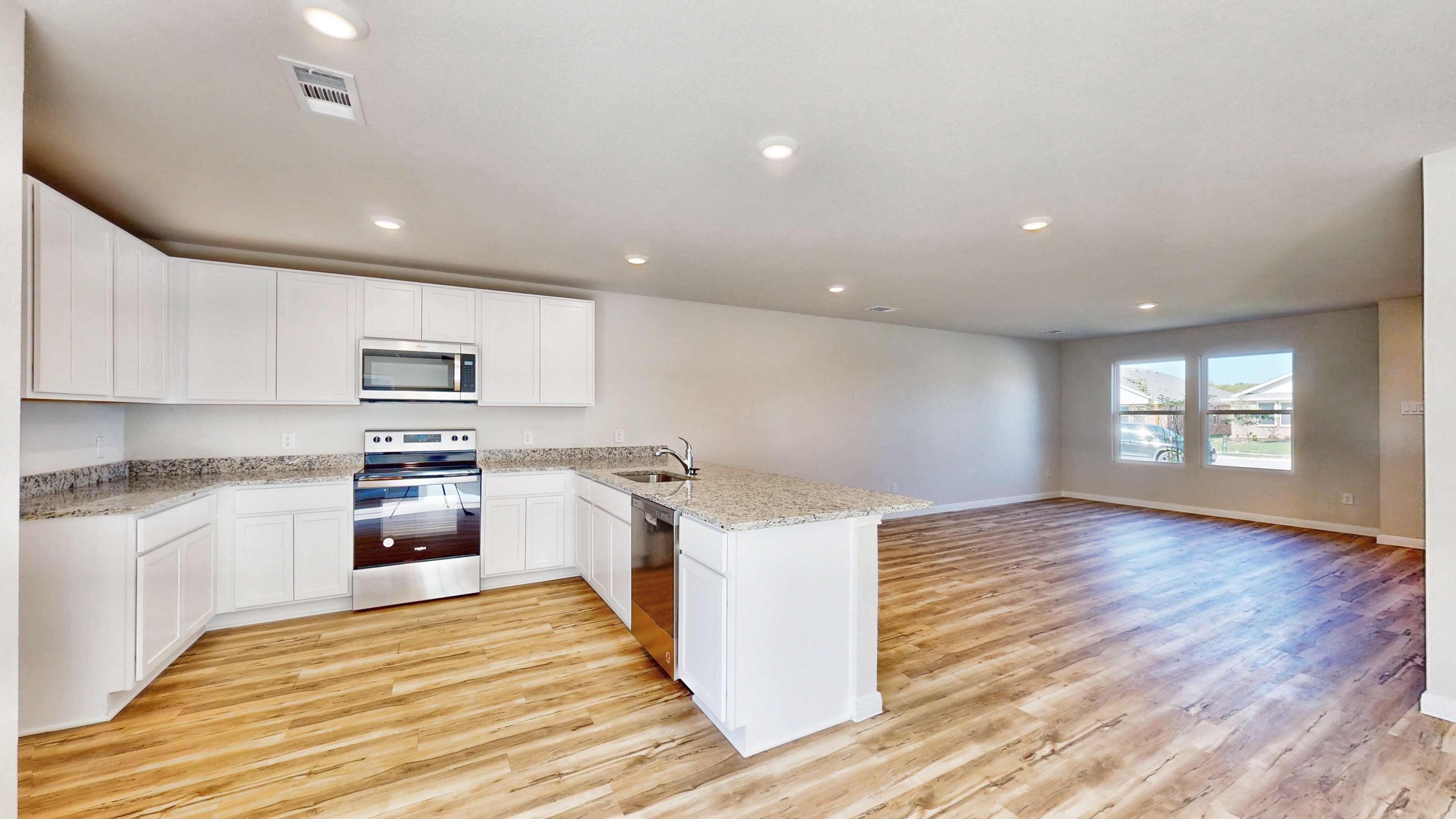 A kitchen with white cabinets.