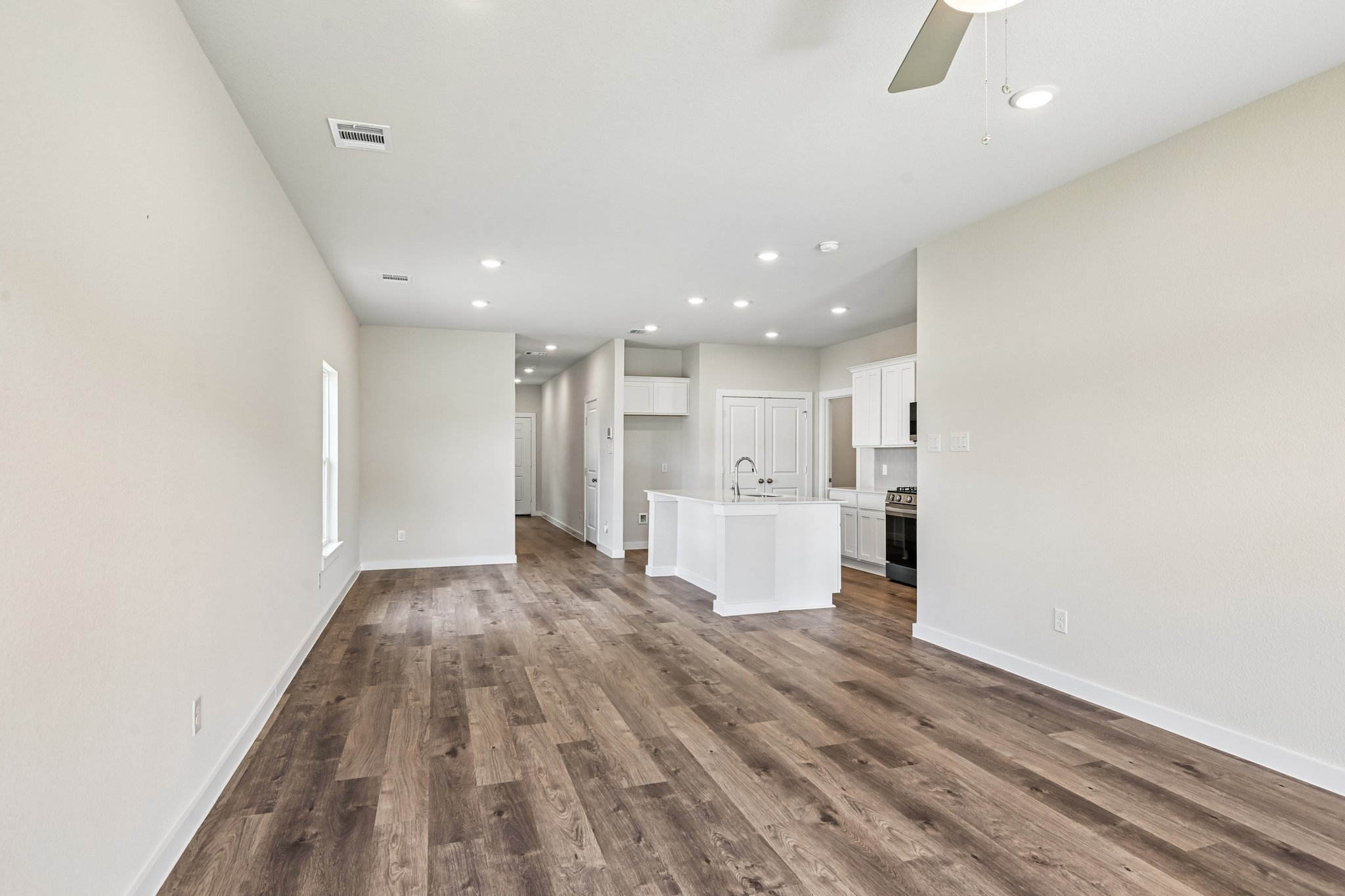 A kitchen with a wood floor.