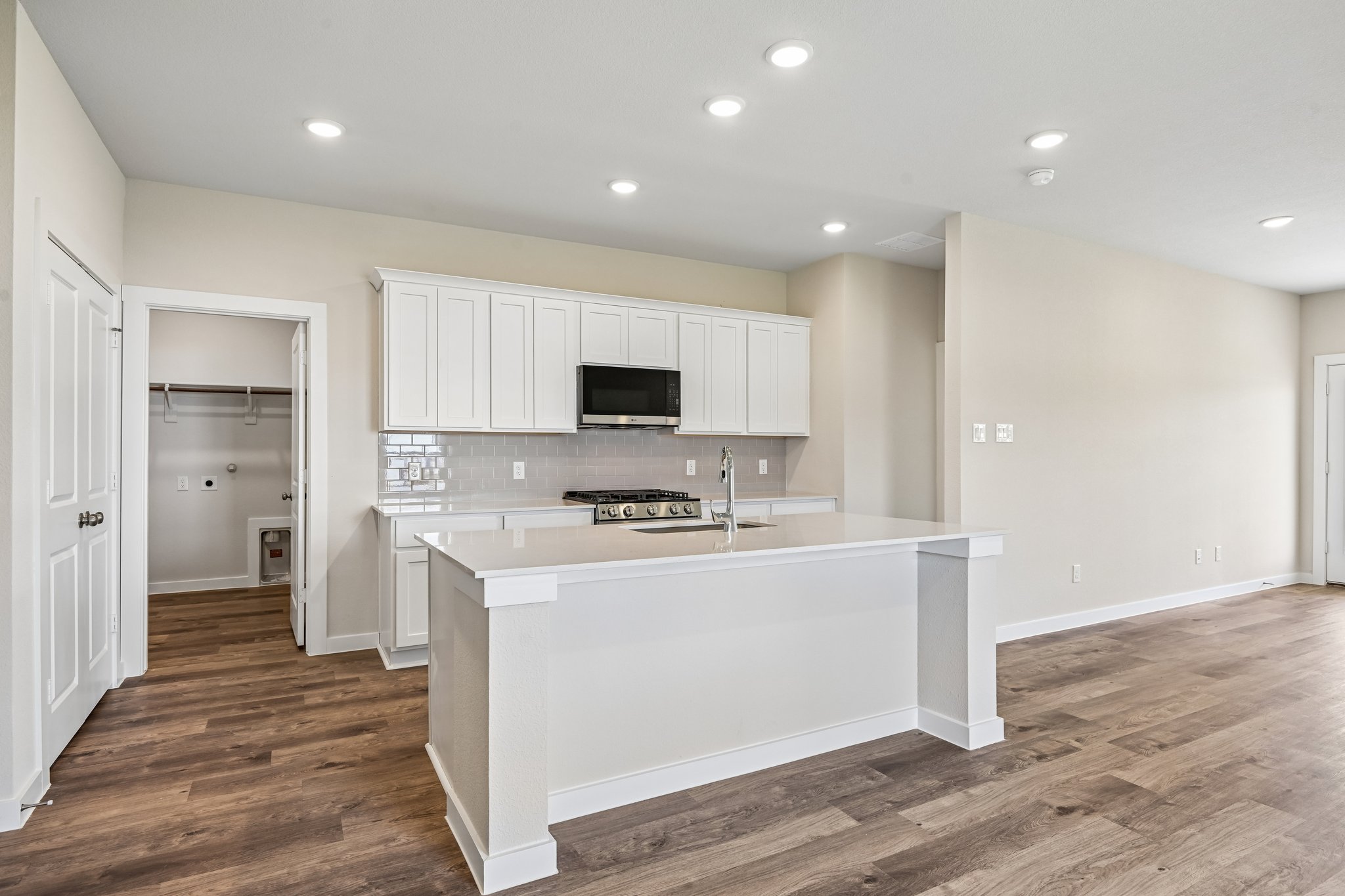 A kitchen with white cabinets.