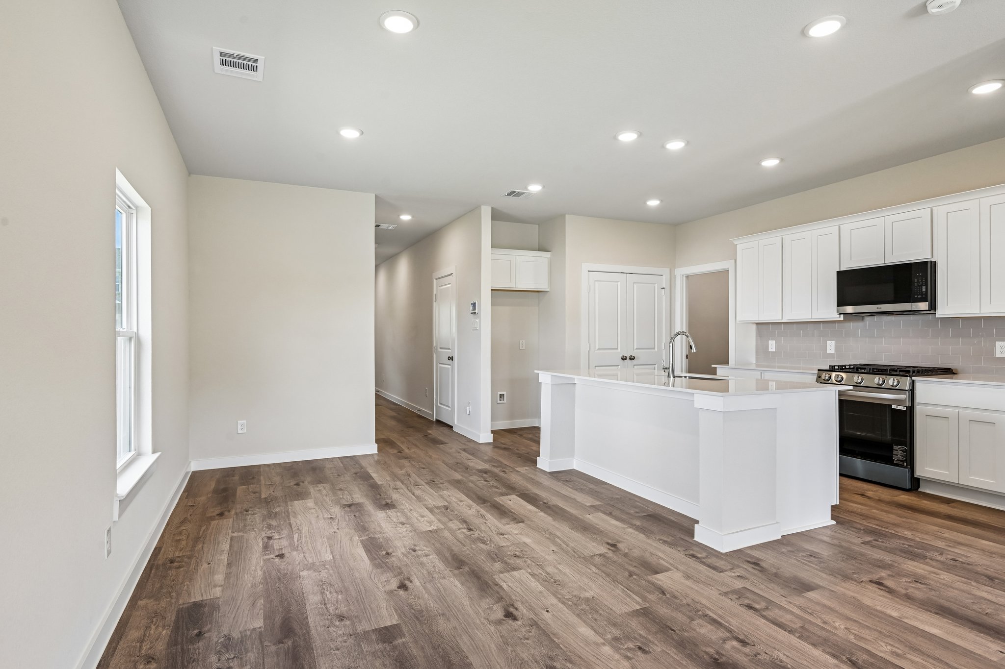 A kitchen with white cabinets.