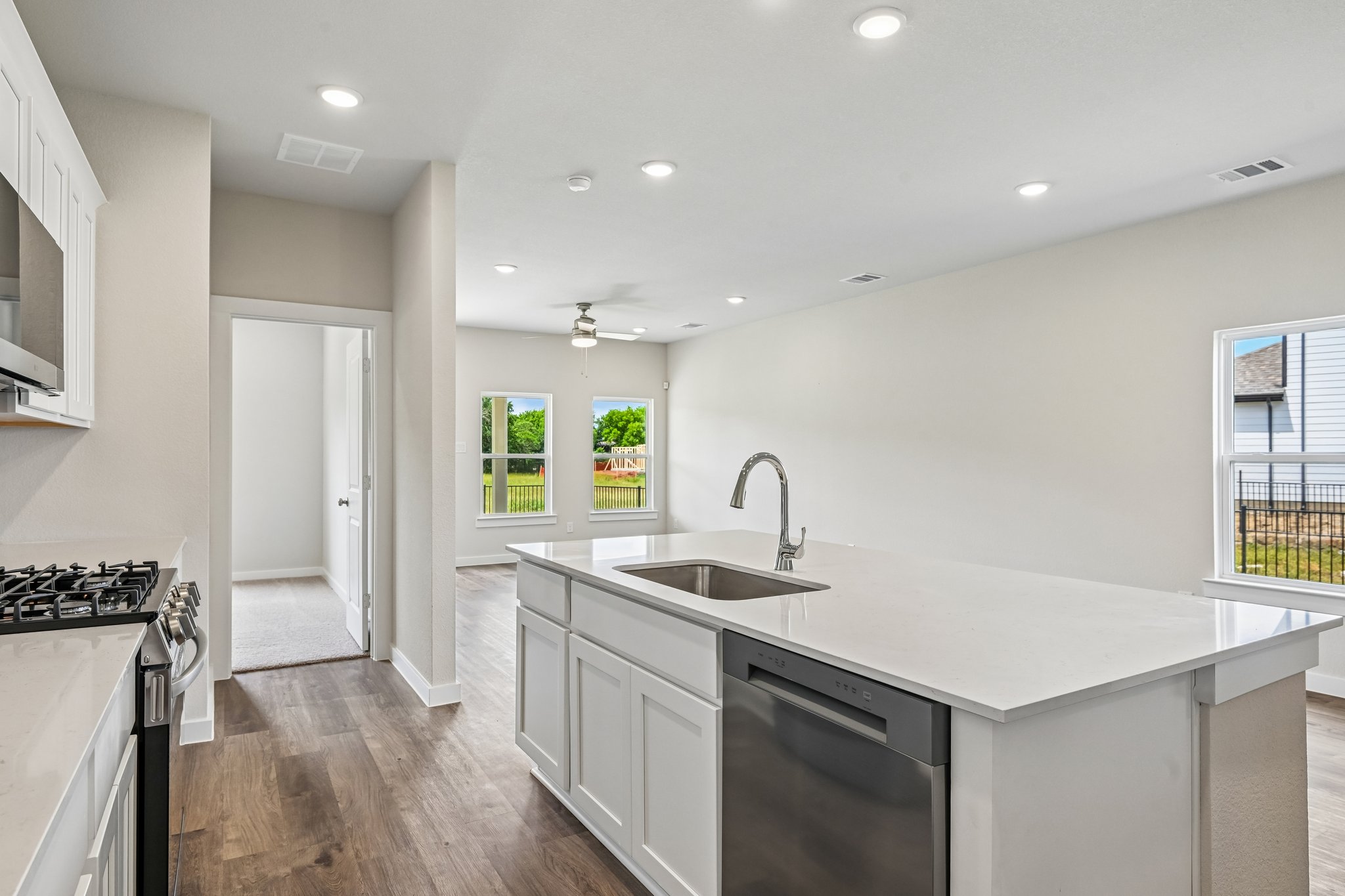 A kitchen with white cabinets.
