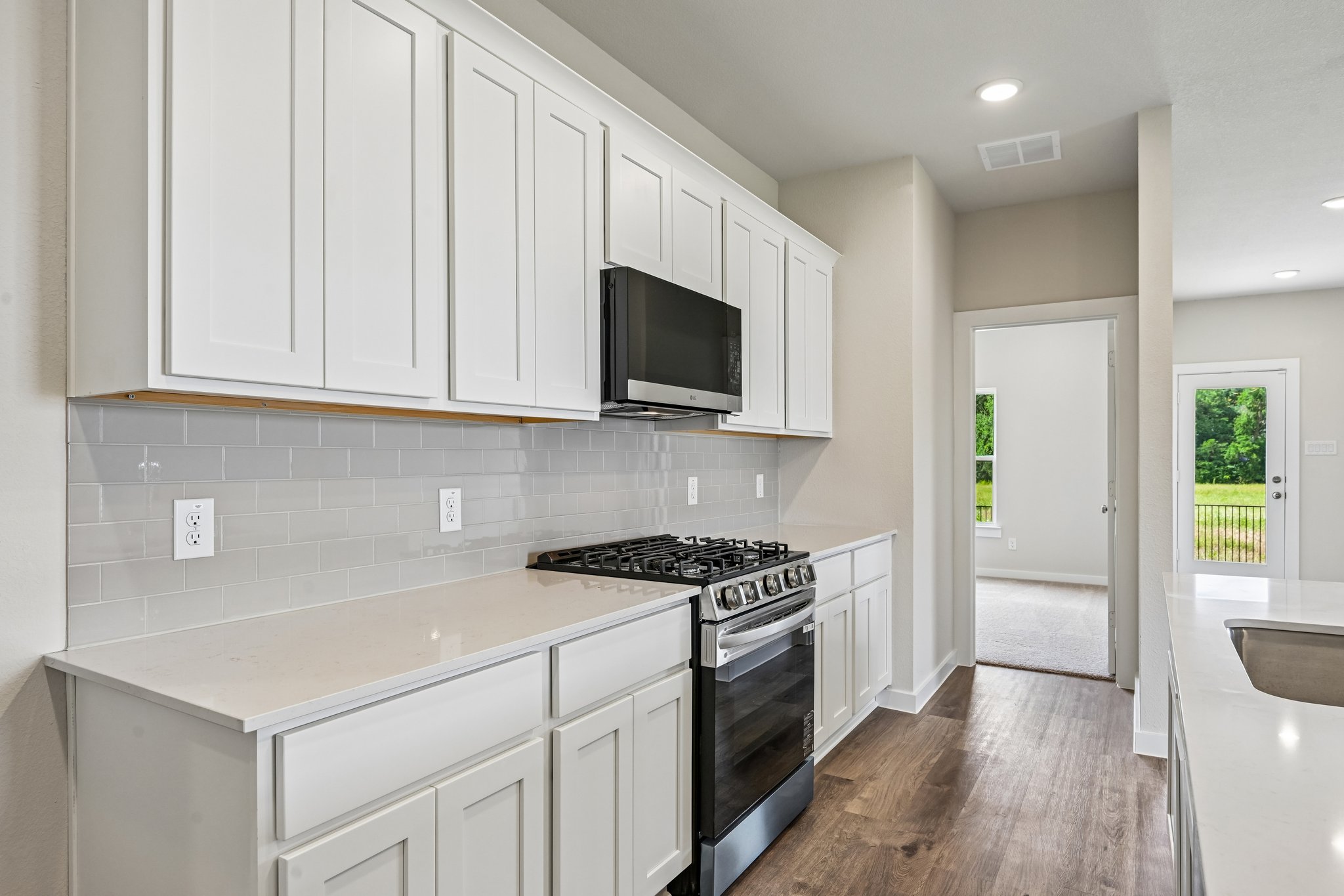 A kitchen with white cabinets.