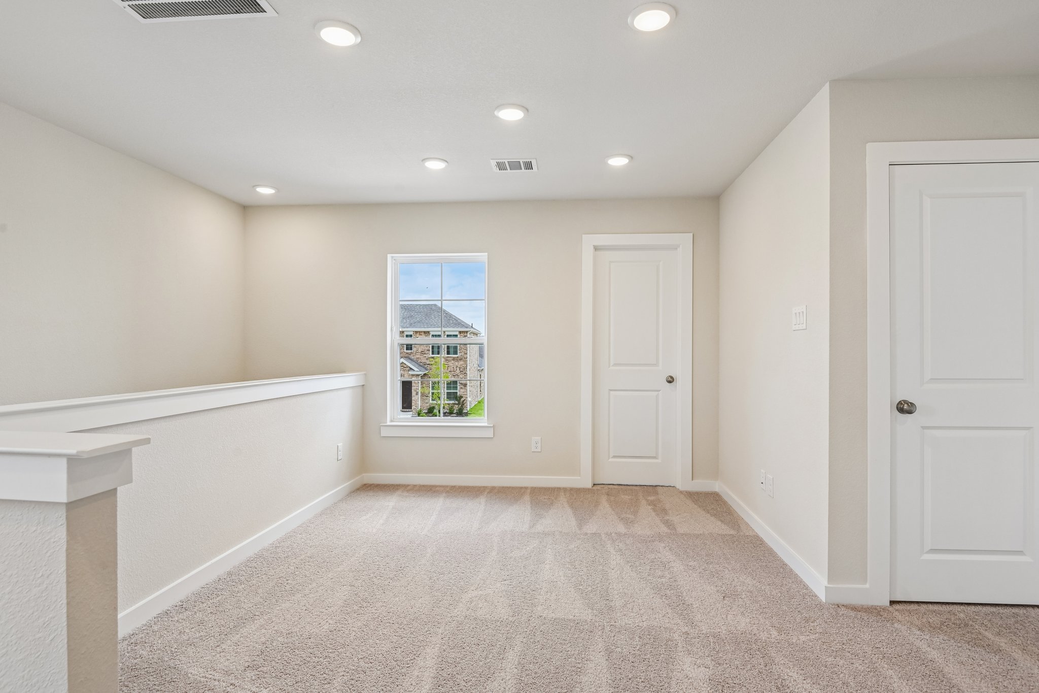 A room with white walls and a white bench.