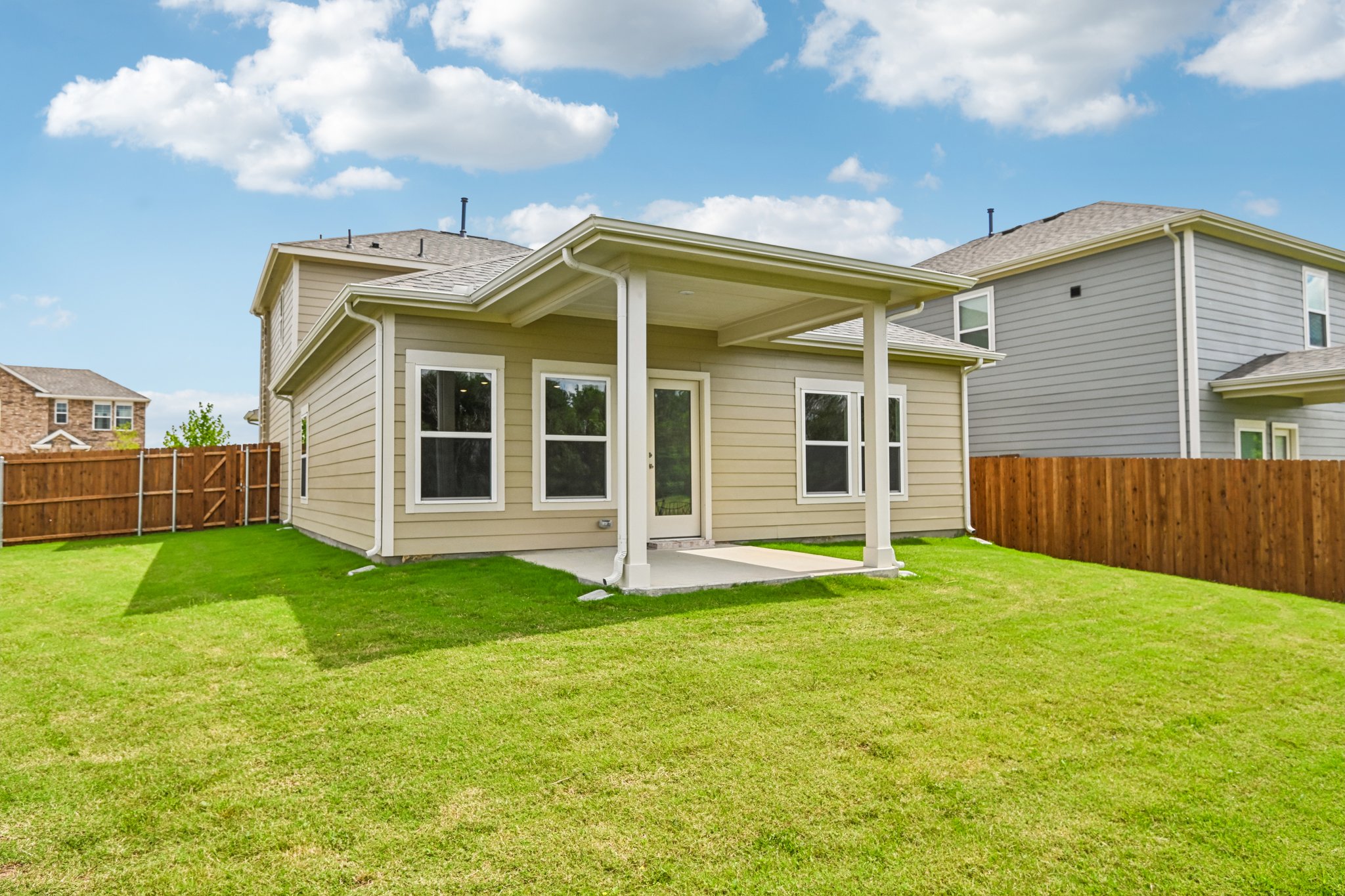 A house with a fence and grass.