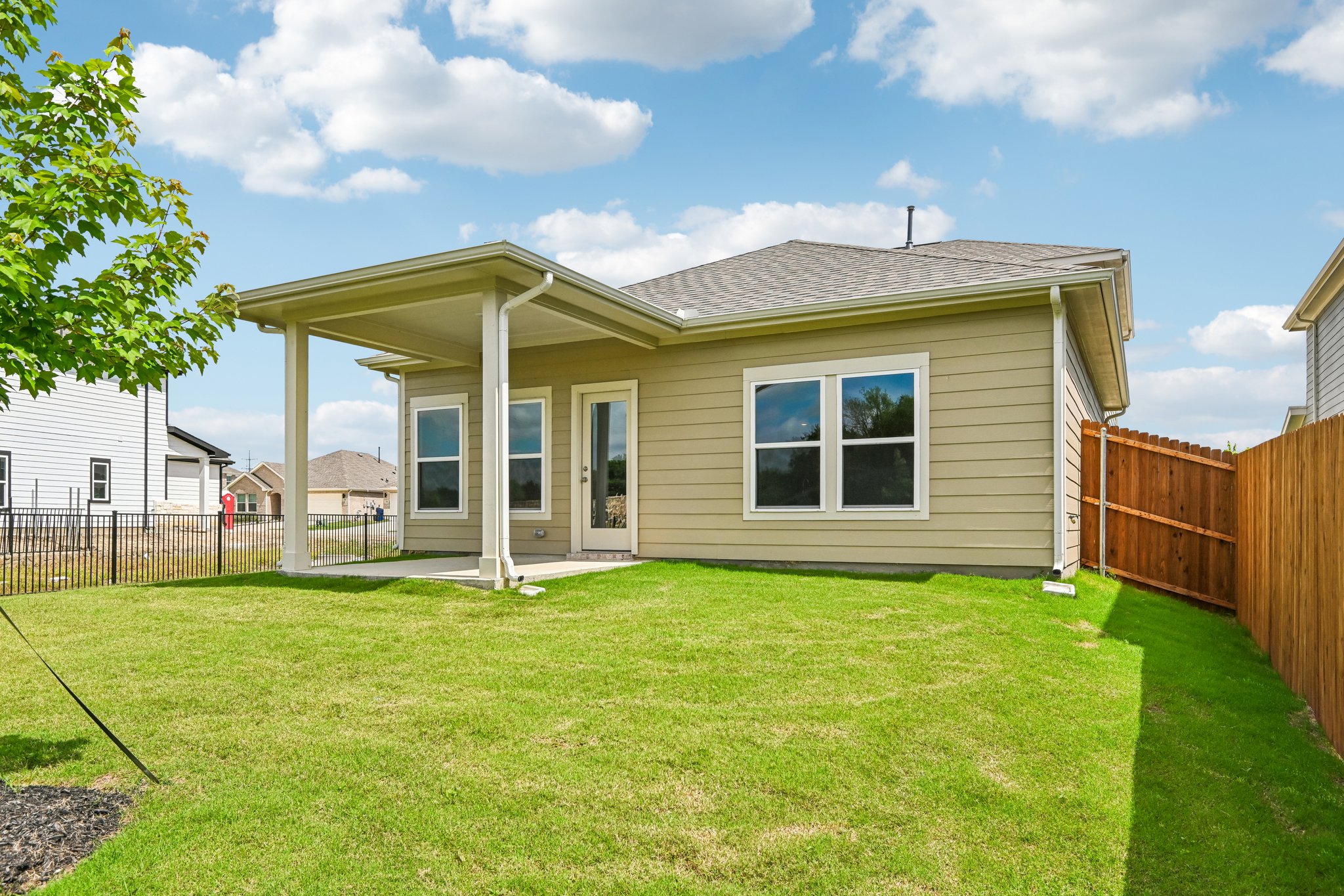 A house with a fence and grass.