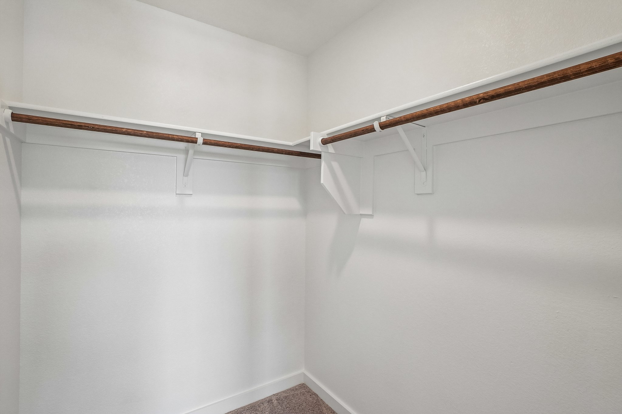 A white wall with a wood railing.