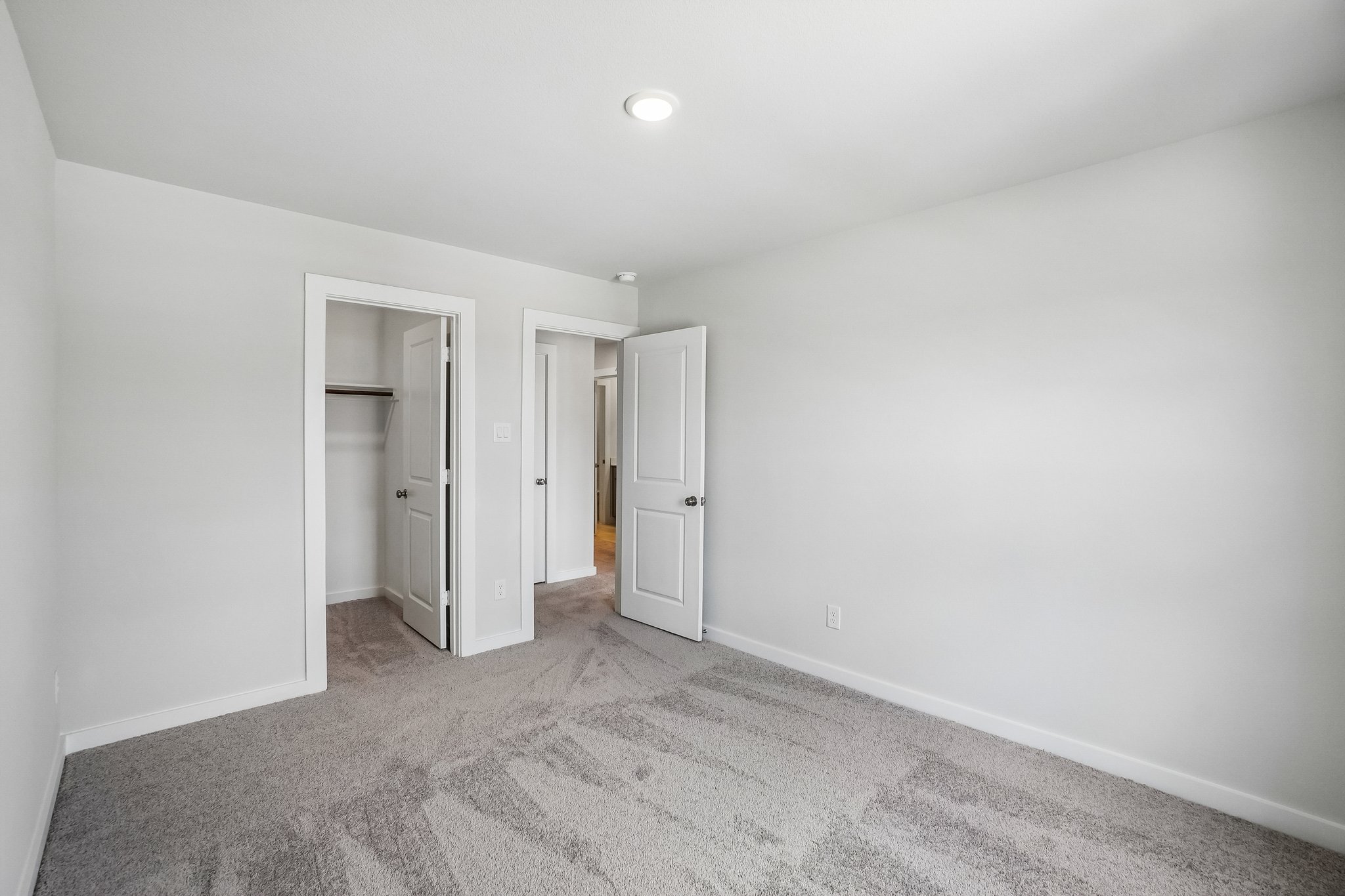 A hallway with white walls.