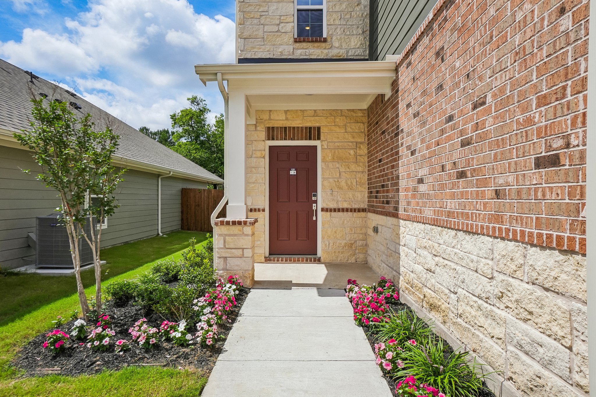 A brick building with a door and a driveway.