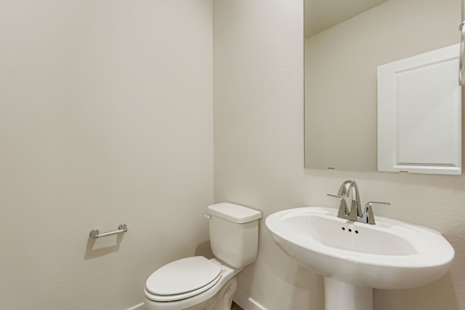 A bathroom with a toilet and sink.