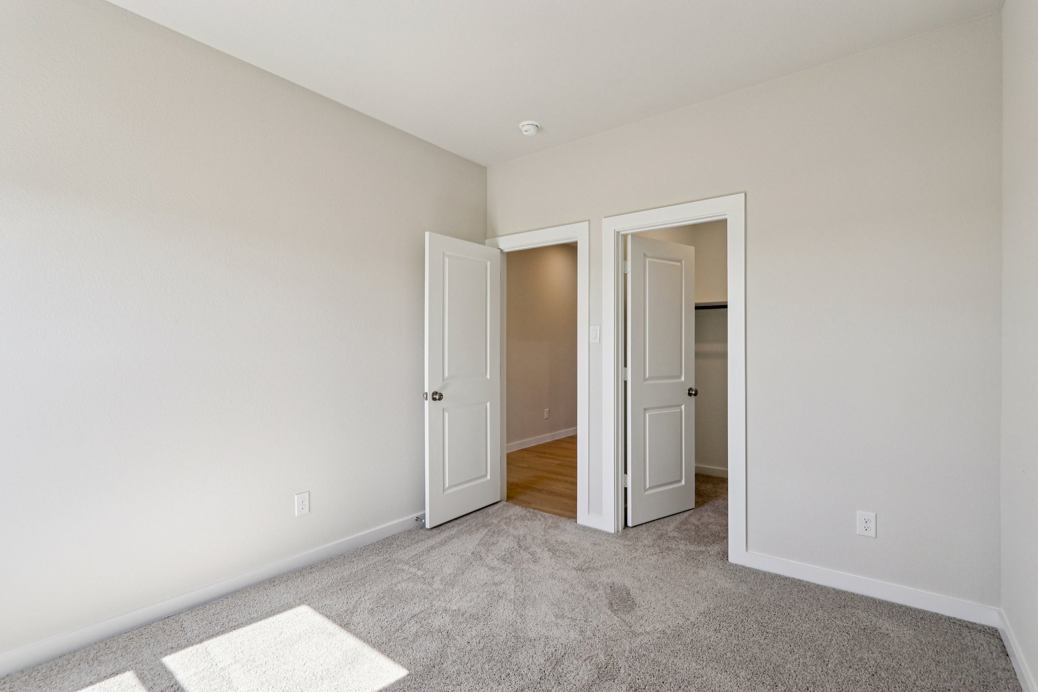 A hallway with white walls.