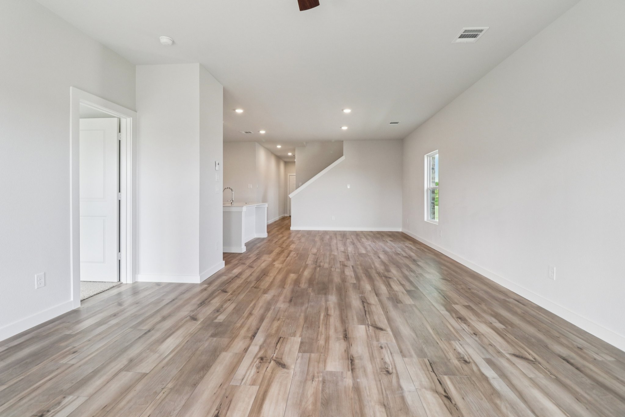 A long hallway with white walls.