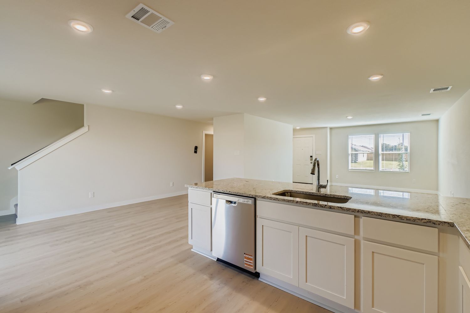 A kitchen with white cabinets.