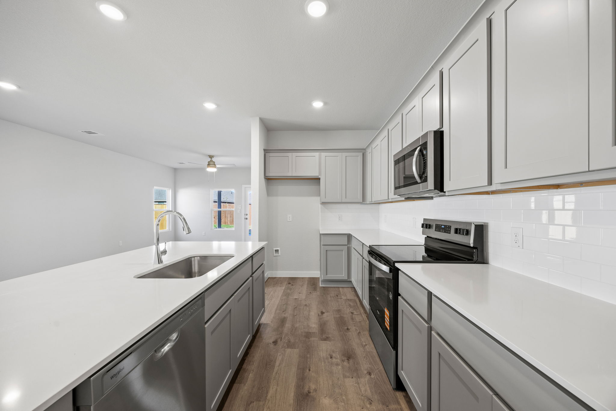 A kitchen with white cabinets.