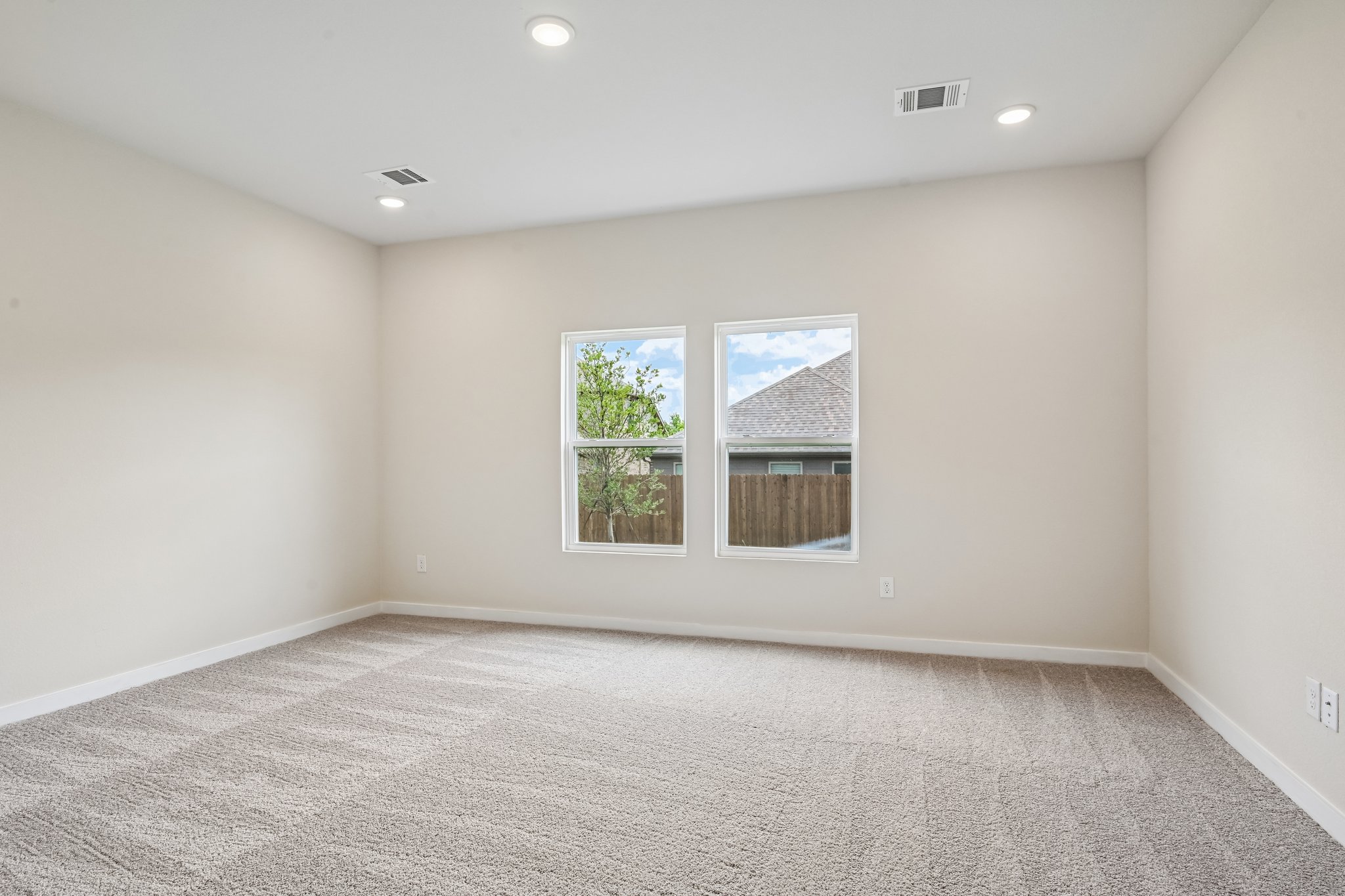 A room with a window and carpet.