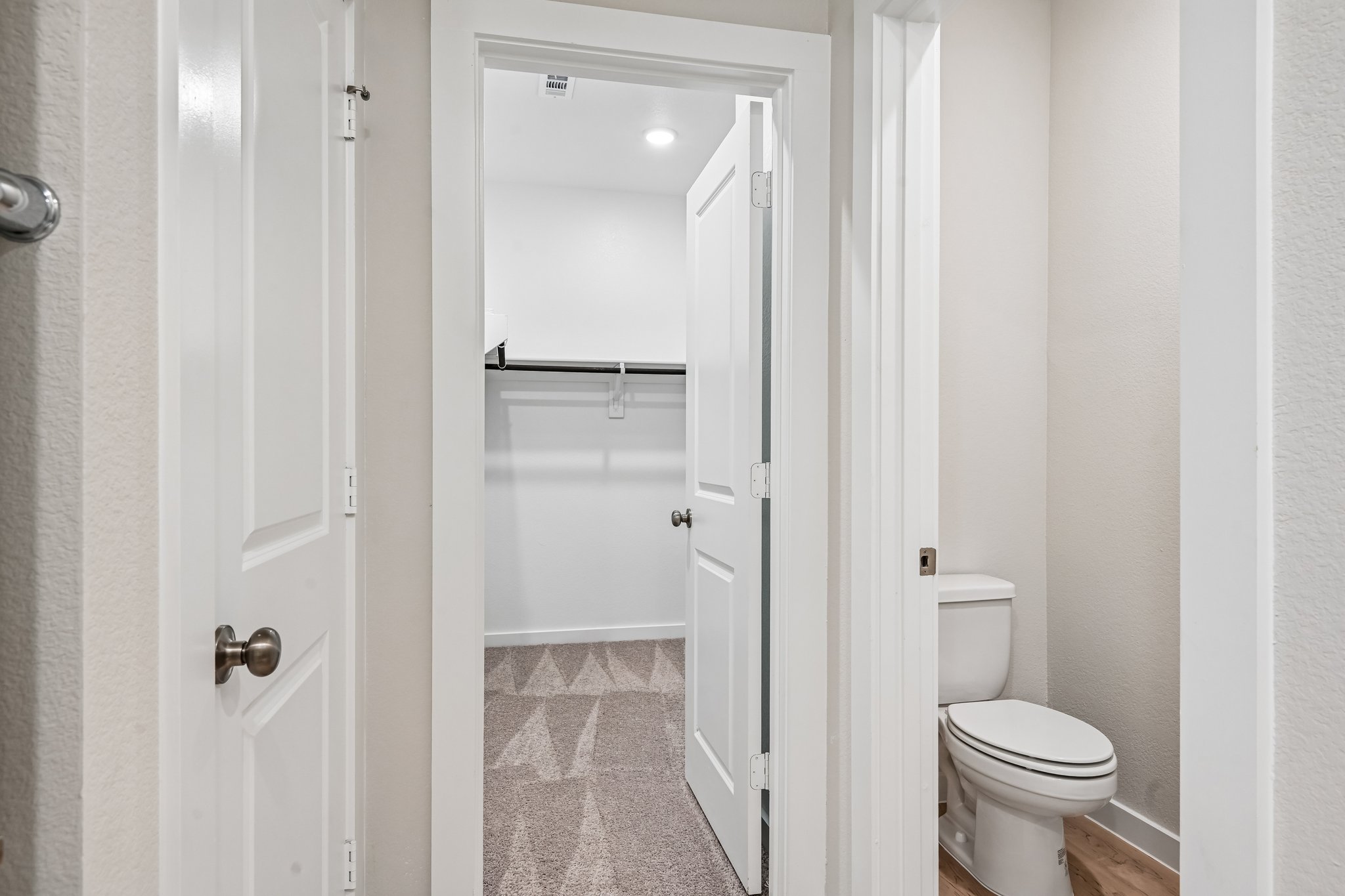 A bathroom with a shower unit and toilet.