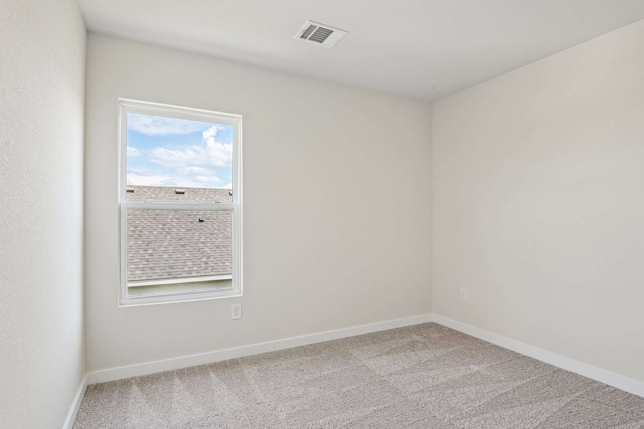 A room with a painting on the wall.