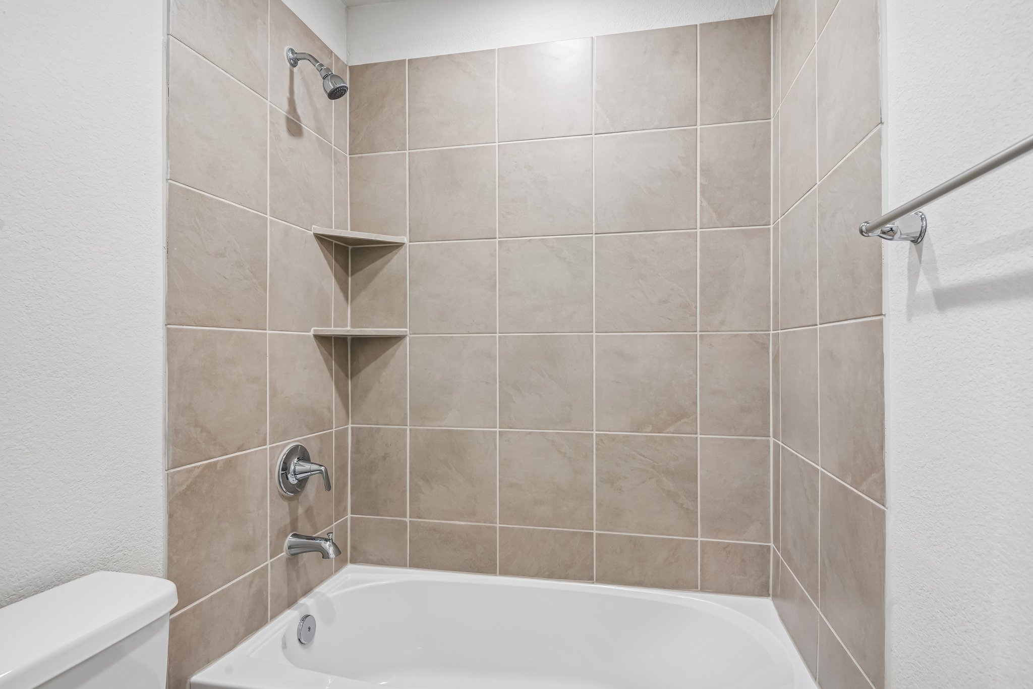 A bathroom with a bathtub and toilet.