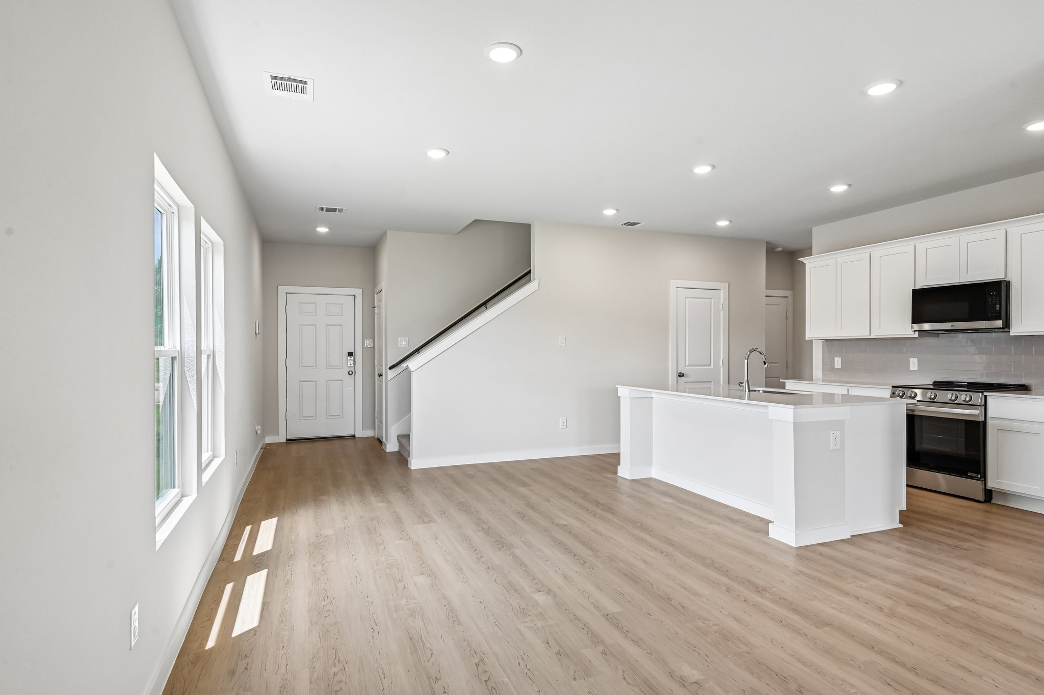 A kitchen with white cabinets.