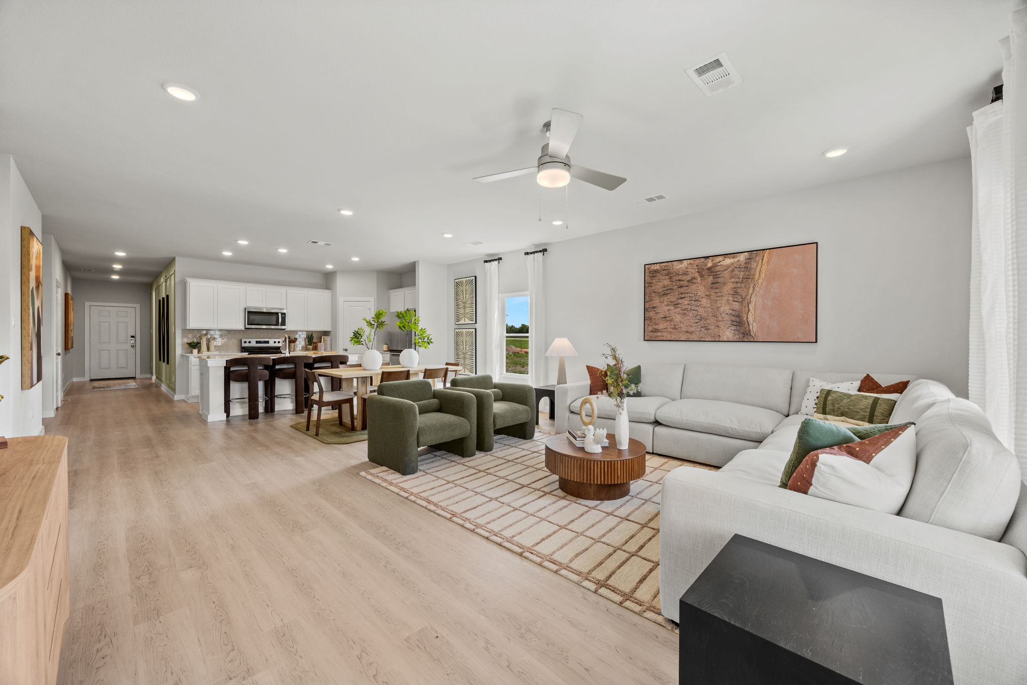A large living room with a wood floor.